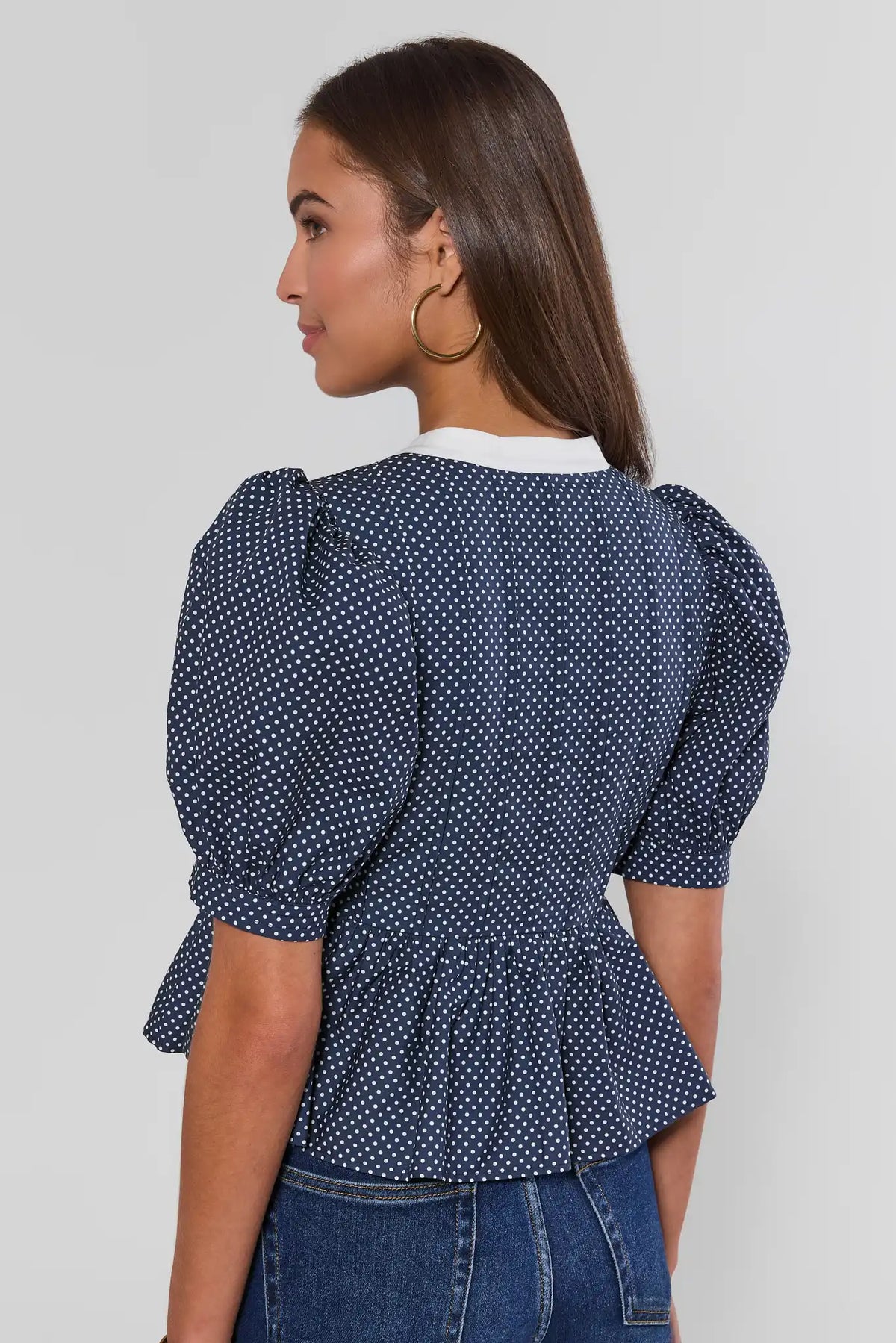 Navy Polka Dot Peplum Top with Puff Sleeves - Back View On Model | Avara