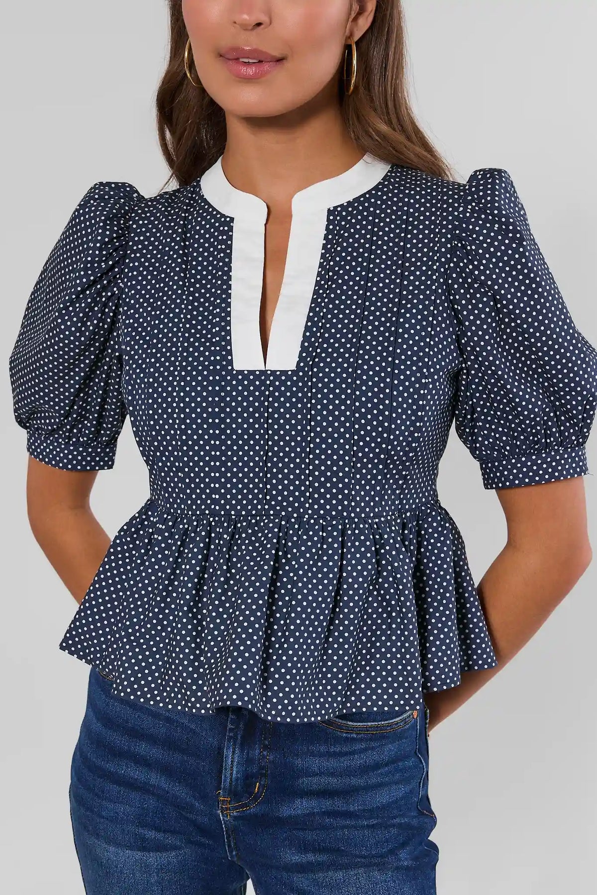 Navy Polka Dot Peplum Top Puff Sleeve and Waist Detail - Close-Up Front | Avara