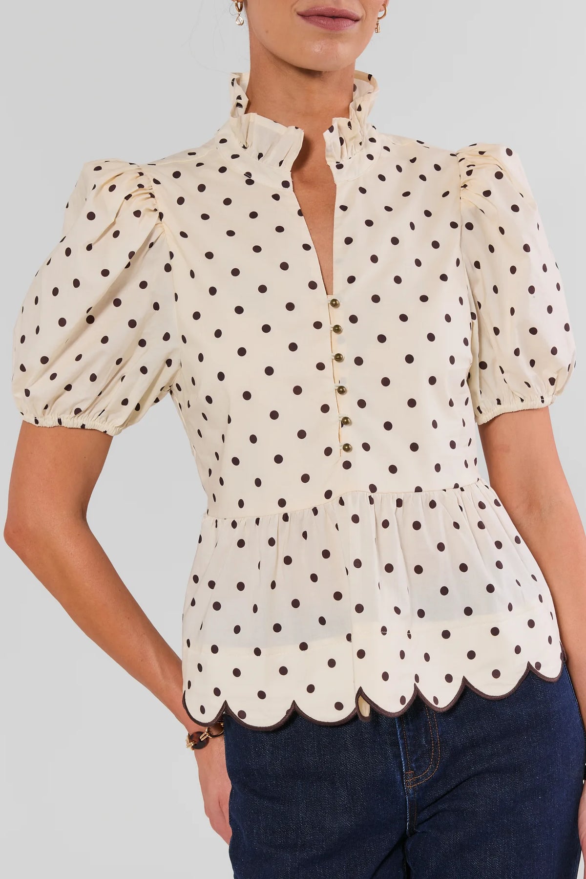Cream Polka Dot Peplum Top - Close-Up Scalloped Hem & Button Detail | Avara
