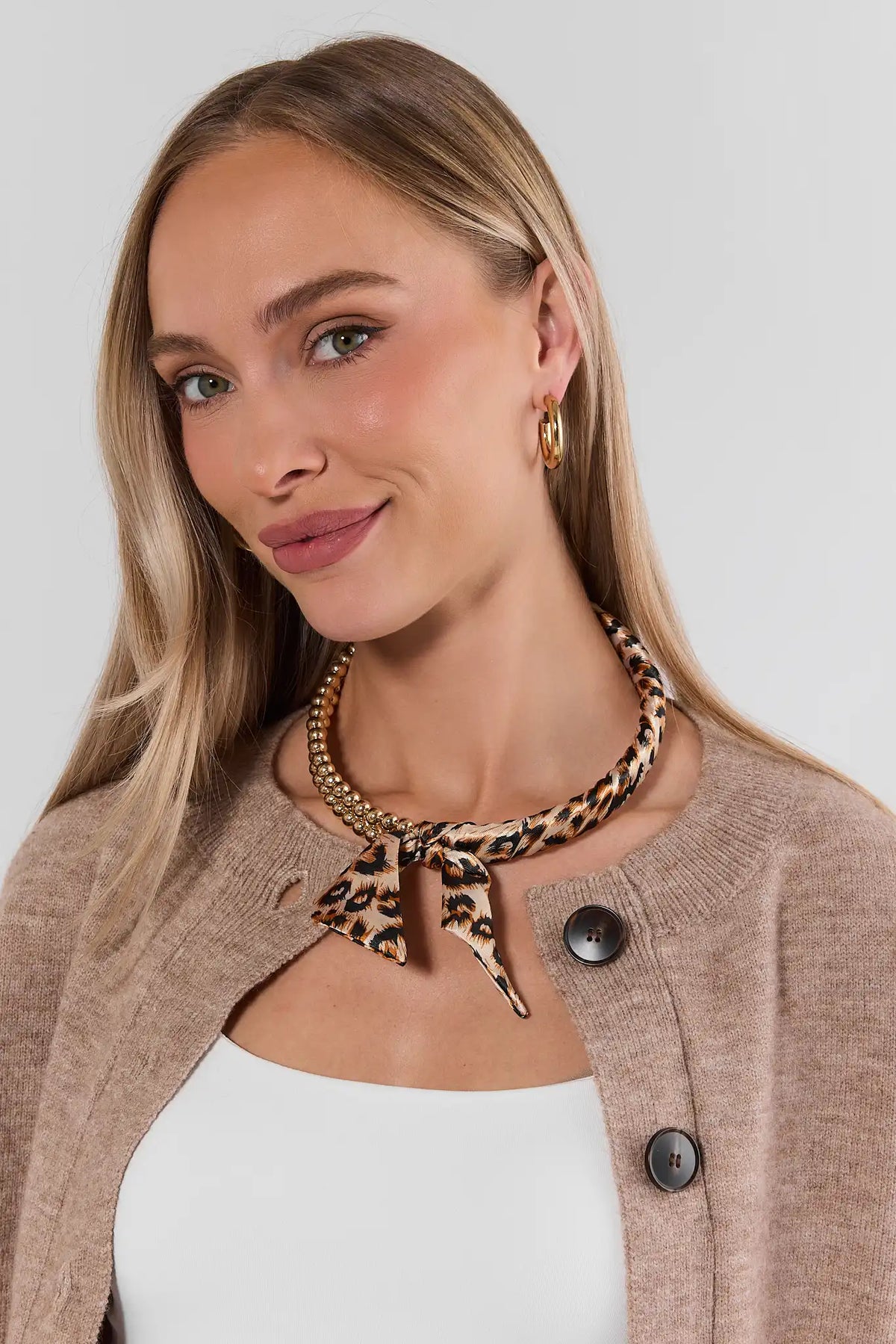 Gold Leopard Print Scarf Necklace Styled On Model with Tan Cardigan | Avara