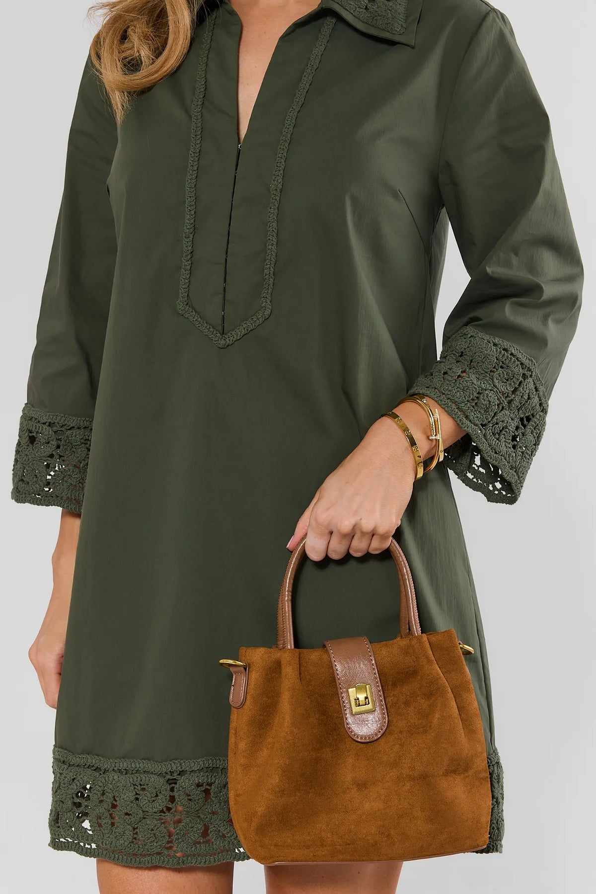 Camel Faux Suede Bucket Bag Held by Model with Green Dress - Styled Look | Avara