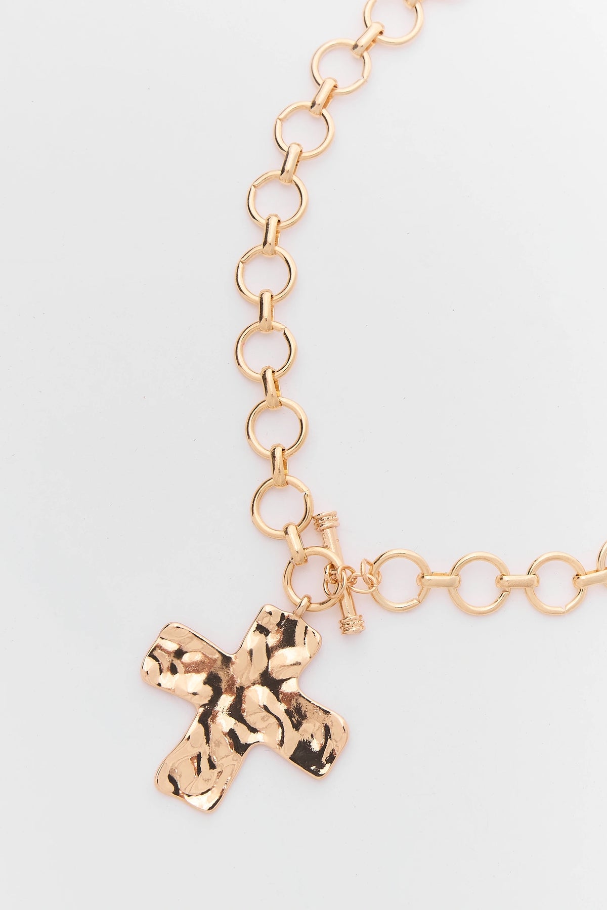 Gold Hammered Cross Pendant Close-Up - Toggle Clasp Detail | Avara
