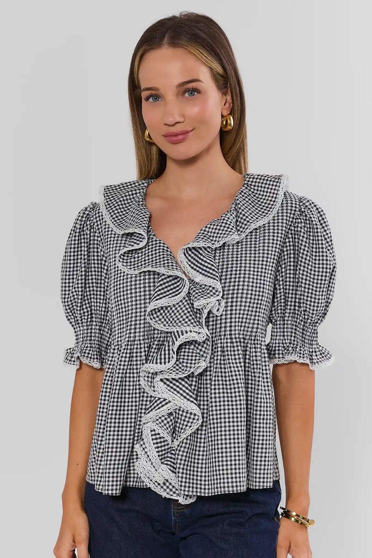 Black gingham ruffle top with lace-trimmed collar and puff sleeves, on model - Front View | Avara