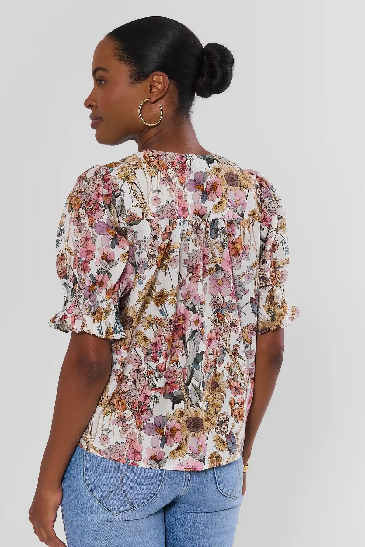 White Floral Printed Pleated Top - Back View Showing Smocked Detail and Ruffle Cuffs | Avara