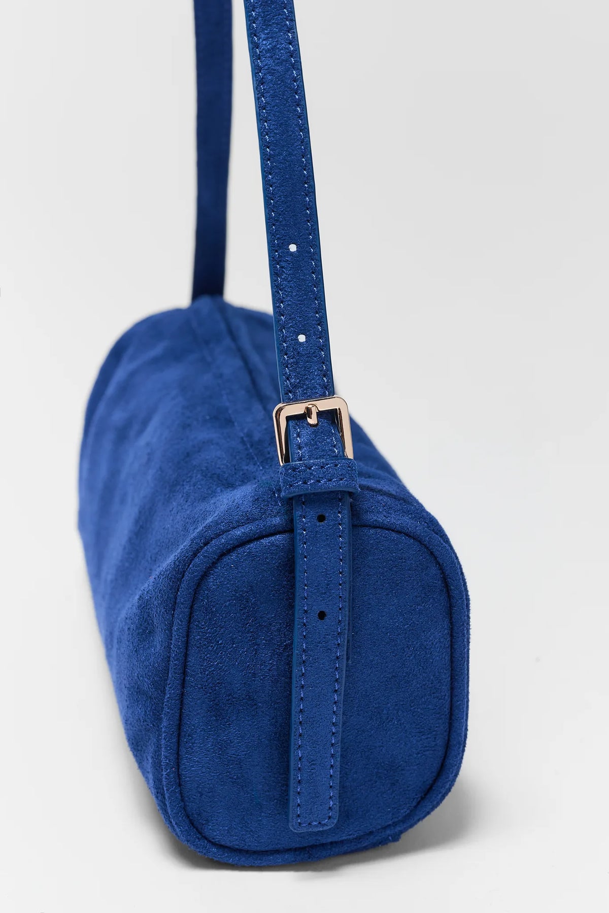 Blue Faux Suede Barrel Bag - Side View with Adjustable Strap | Avara