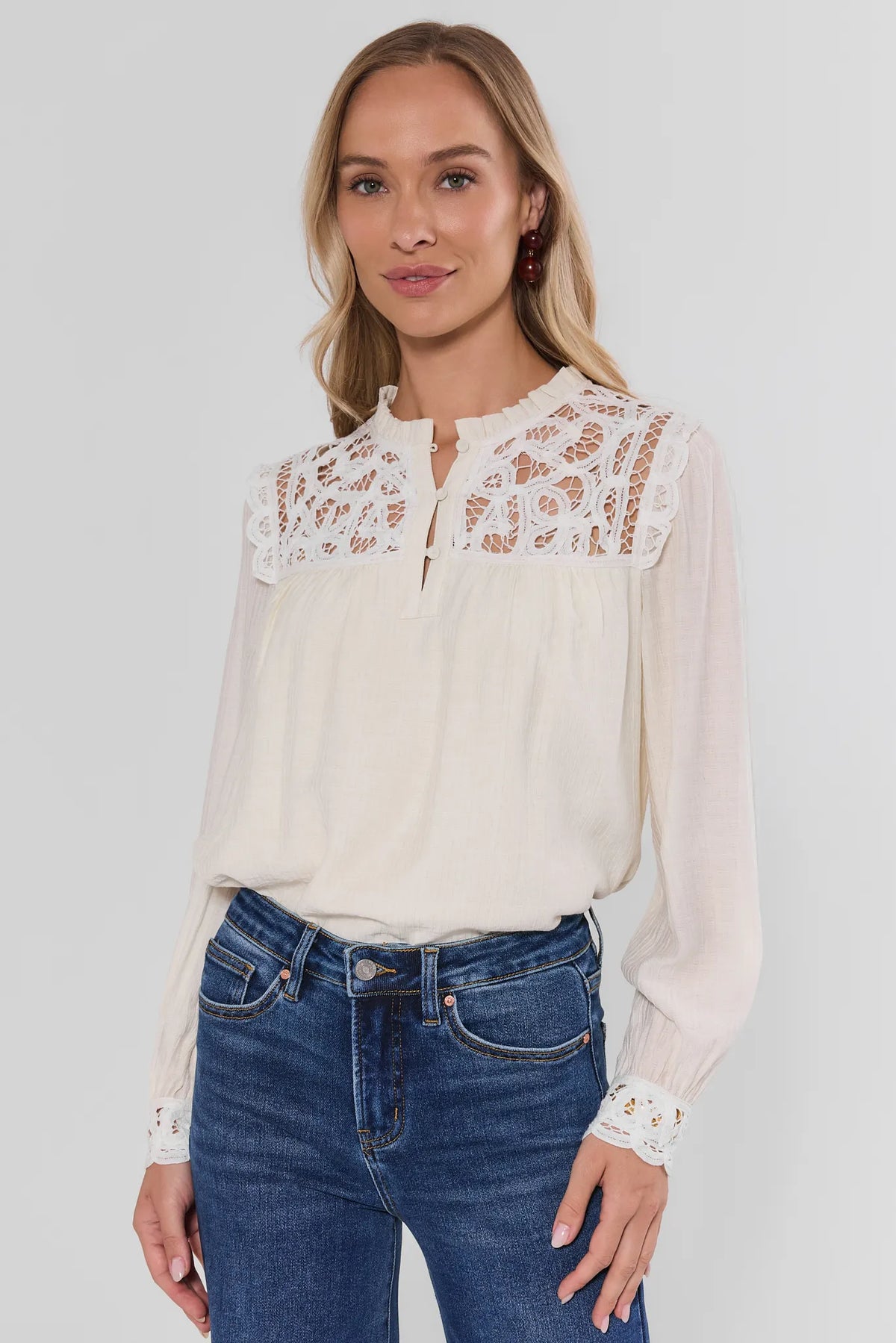 White Eyelet Trim Long Sleeve Top - On Model Side Angle with Denim | Avara