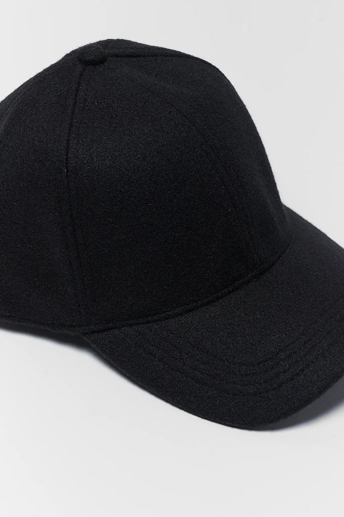 Black Faux Wool Baseball Cap - Close-Up Fabric Texture Detail | Avara