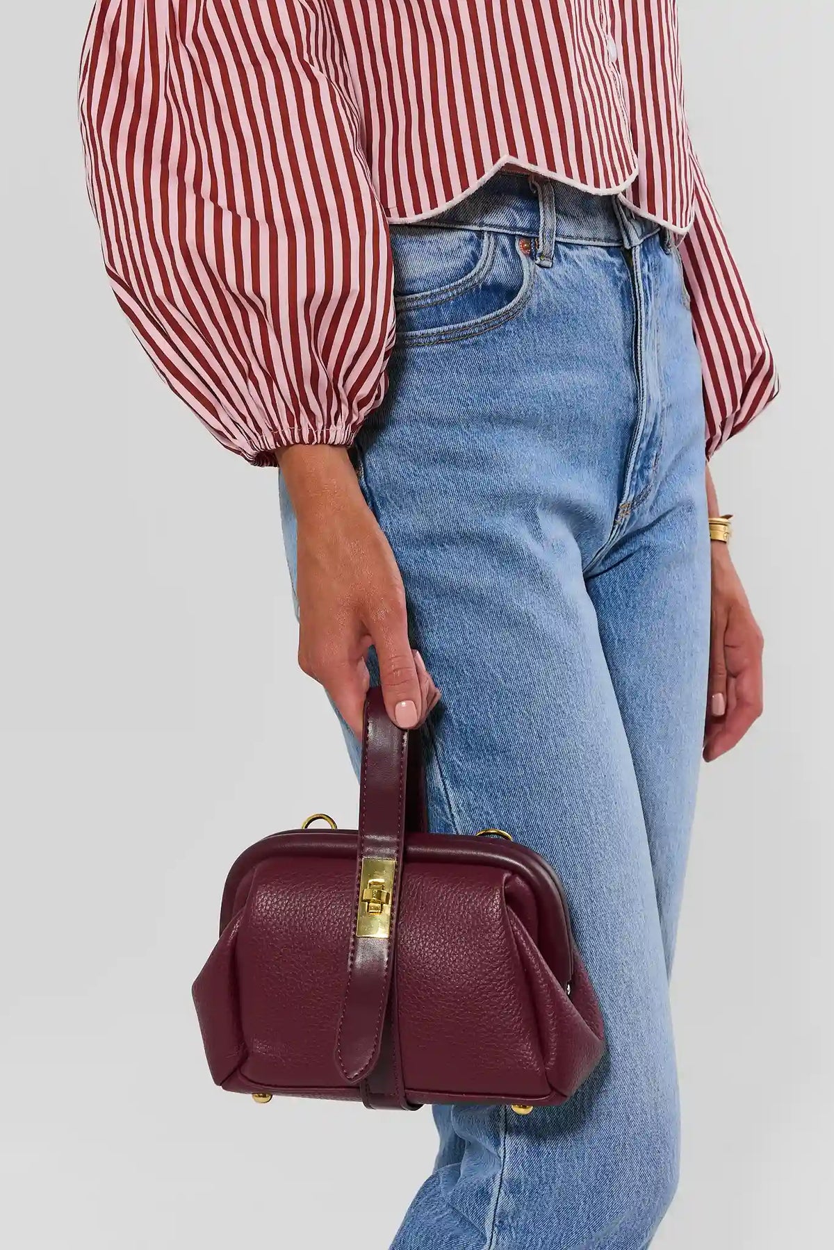 Burgundy Faux Leather Mini Bag - On Model Hand Carry View with Gold Hardware | Avara