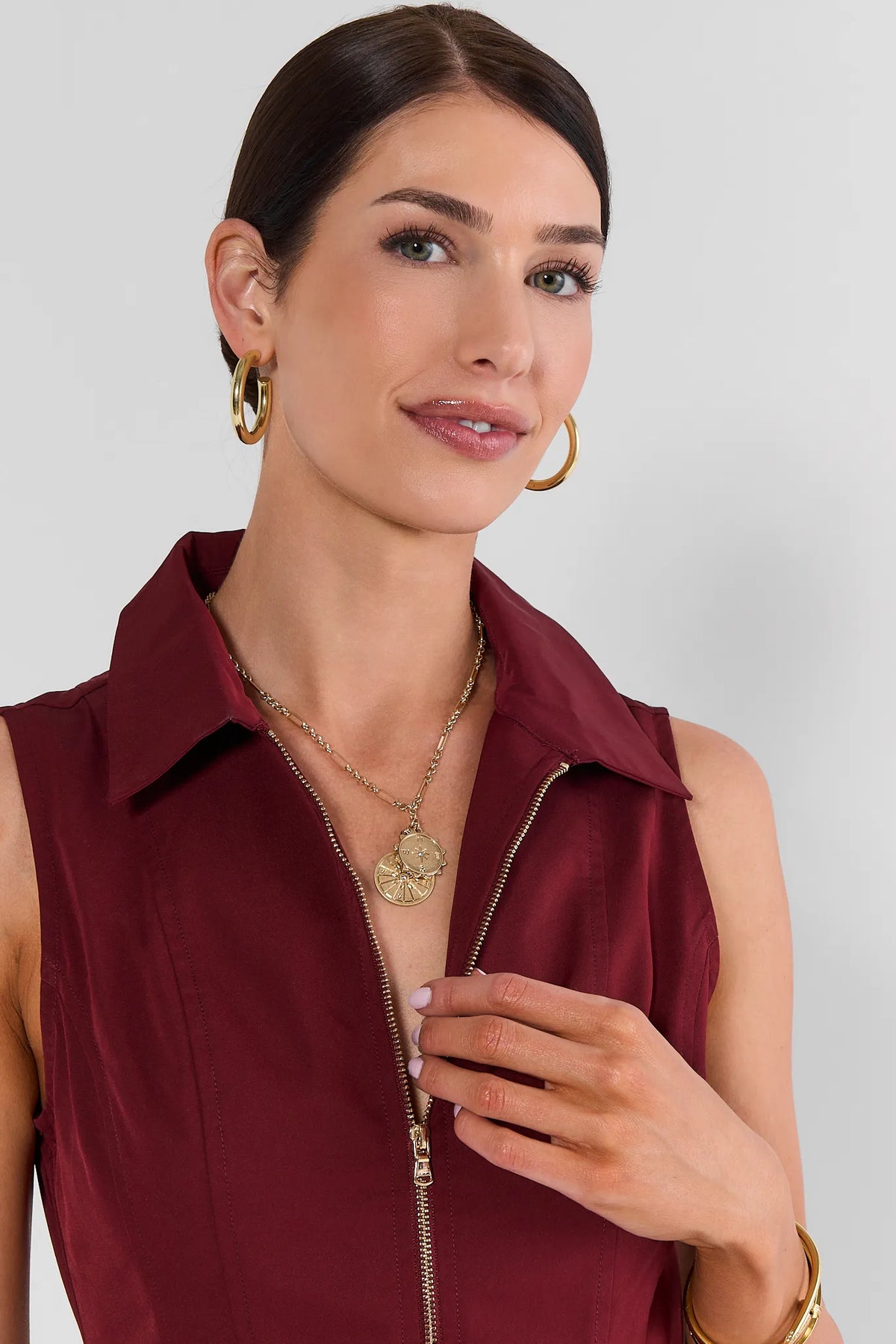 Gold Compass Charm Necklace Styled On Model Over Burgundy Top - Front View | Avara