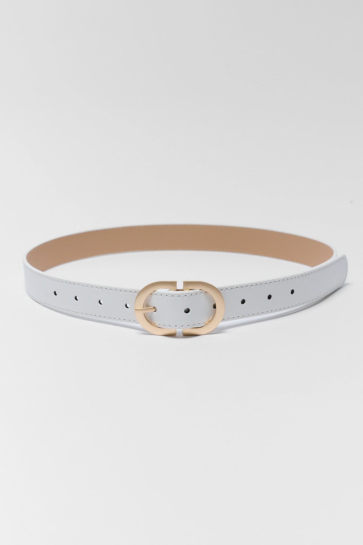 White faux leather belt with gold oval buckle laid flat, plain white belt full length view | Avara