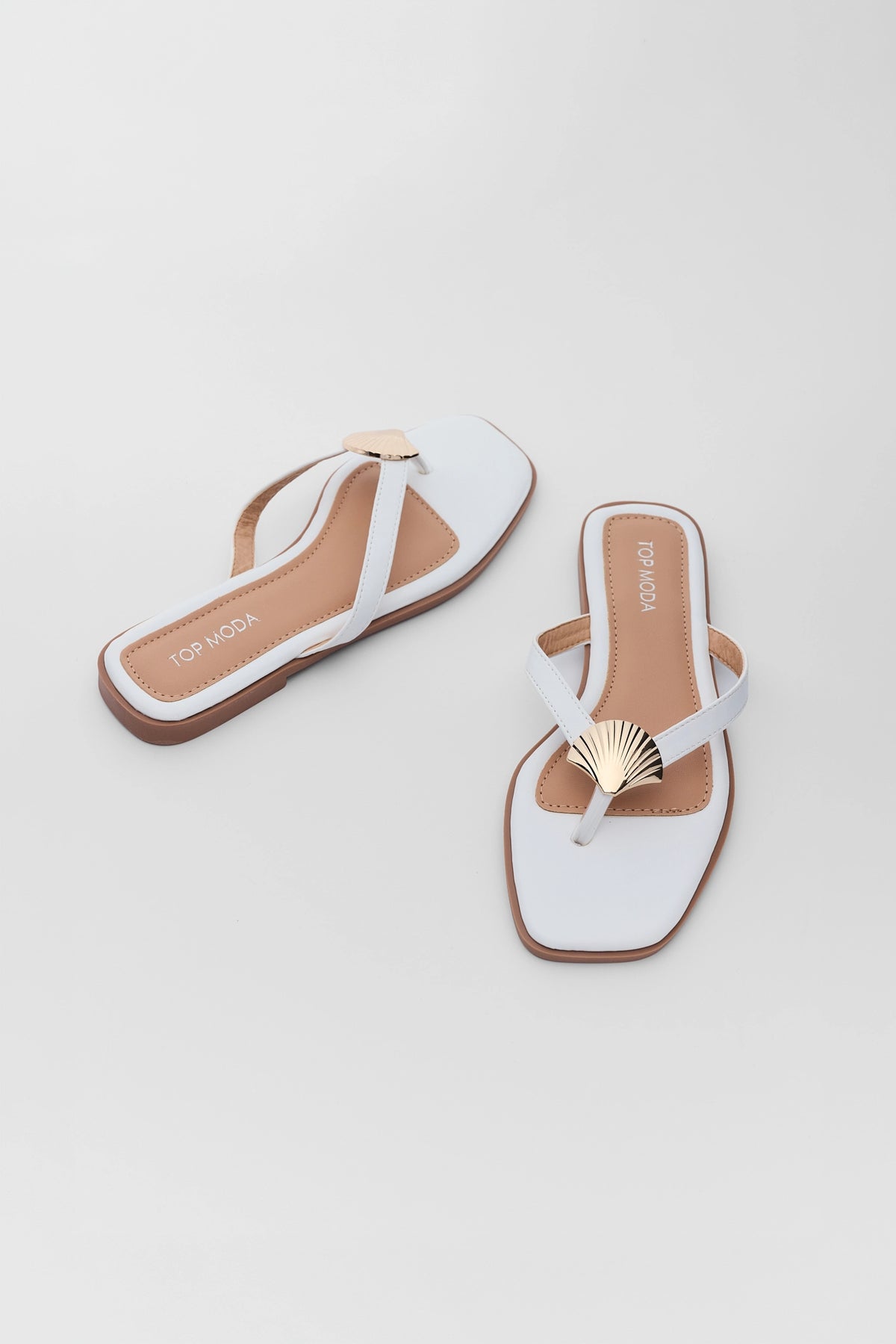White shell detail sandals with gold seashell accent and brown sole - Overhead Pair View | Avara