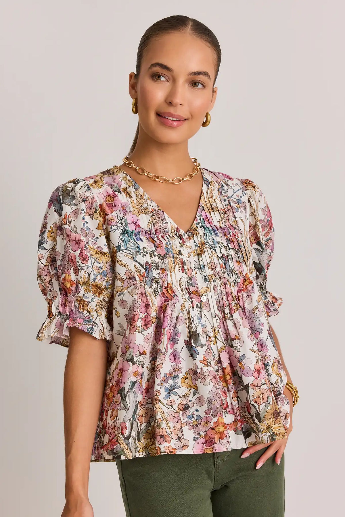 White Floral Pleated Top with V-Neck and Puff Sleeves - Front View on Model | Avara