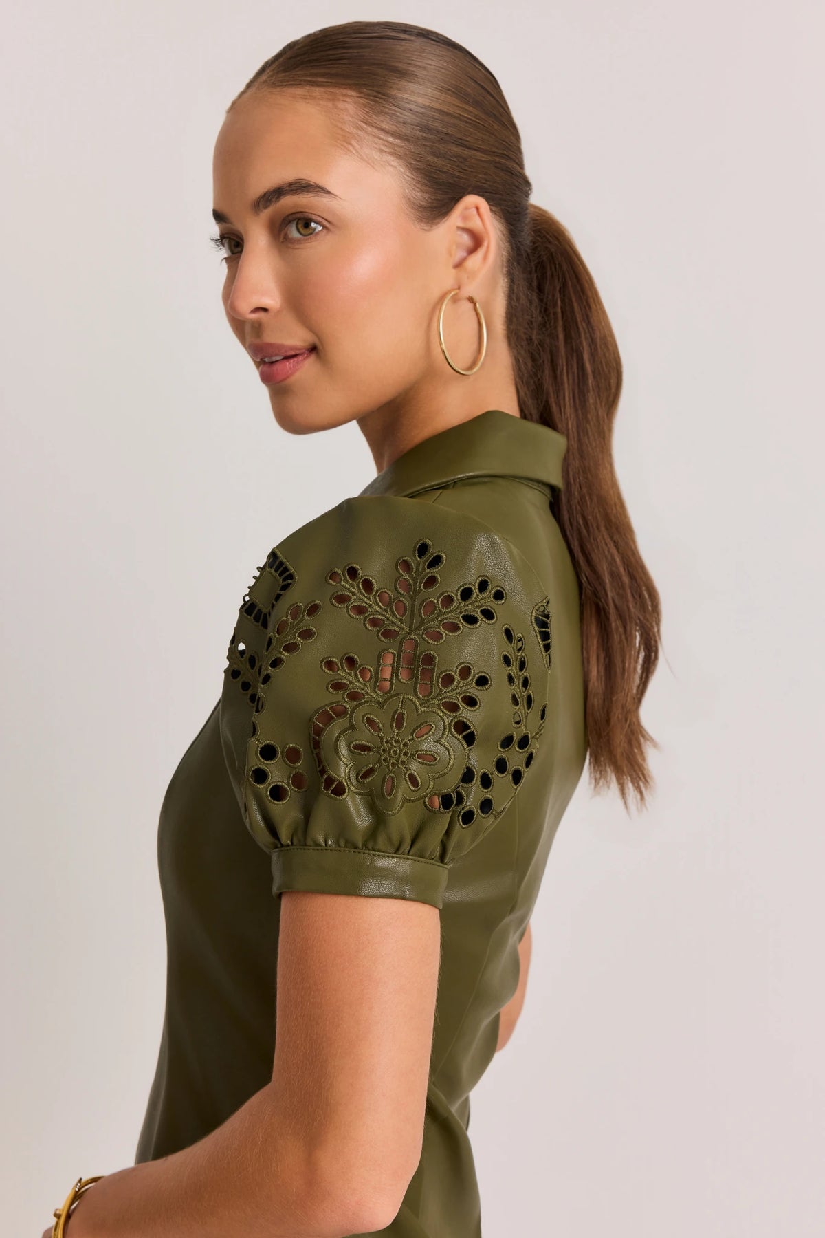 Olive Green Faux Leather Short Dress - Side Profile, Eyelet Puff Sleeve Detail | Avara