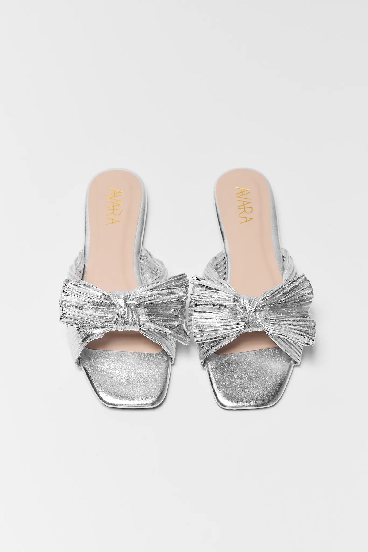Silver metallic knot sandals front-toe view showing pleated bow detail, women's slide | Avara