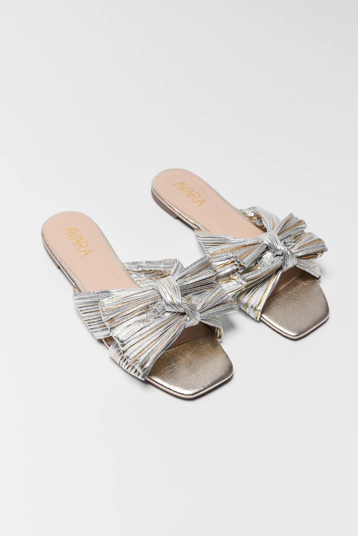 Silver and gold two tone metallic knot sandals - Angled Pair View showing bow detail | Avara