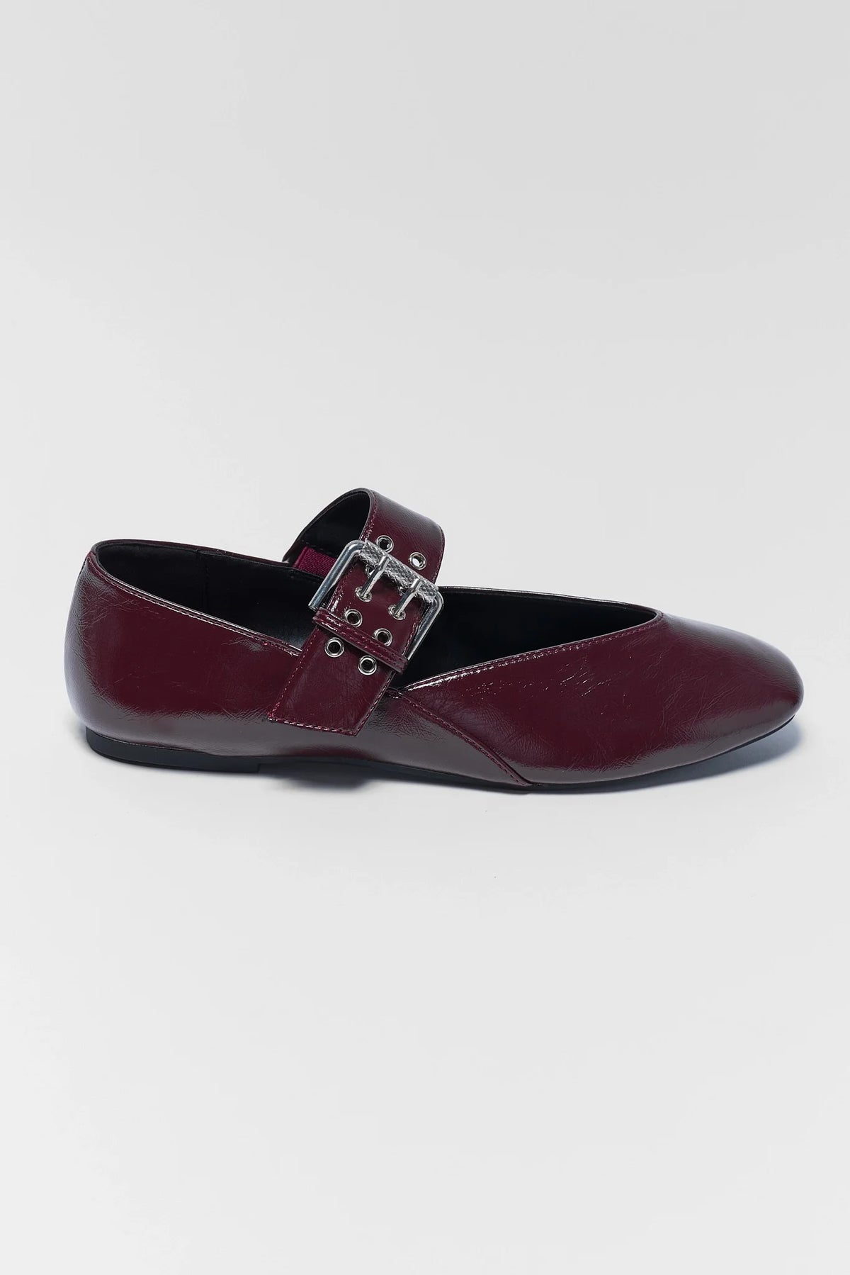 Maroon faux leather women's flat with silver buckle closure - Side Profile | Avara