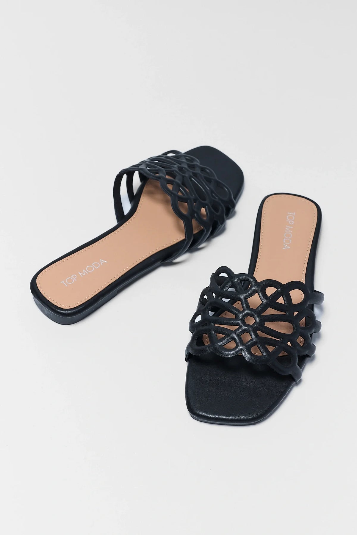 Black faux-leather cutout floral slide sandals - Pair Angled View | Avara