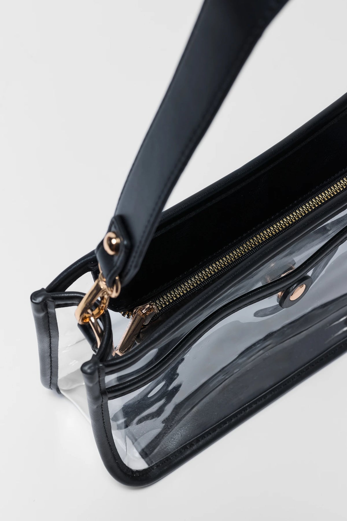 Clear vinyl shoulder bag with black trim, gold zipper, and gold-tone clasp hardware - Hardware Detail | Avara