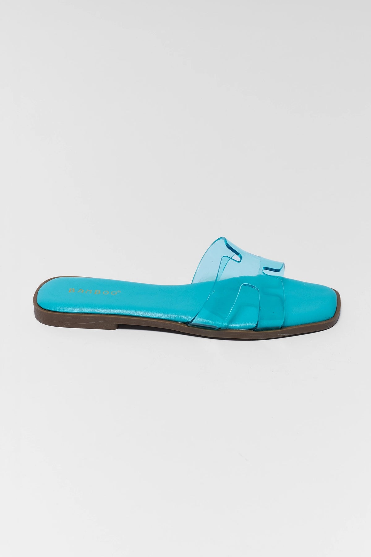 Turquoise blue jelly sandal single shoe side profile view, clear H-strap and brown sole | Avara