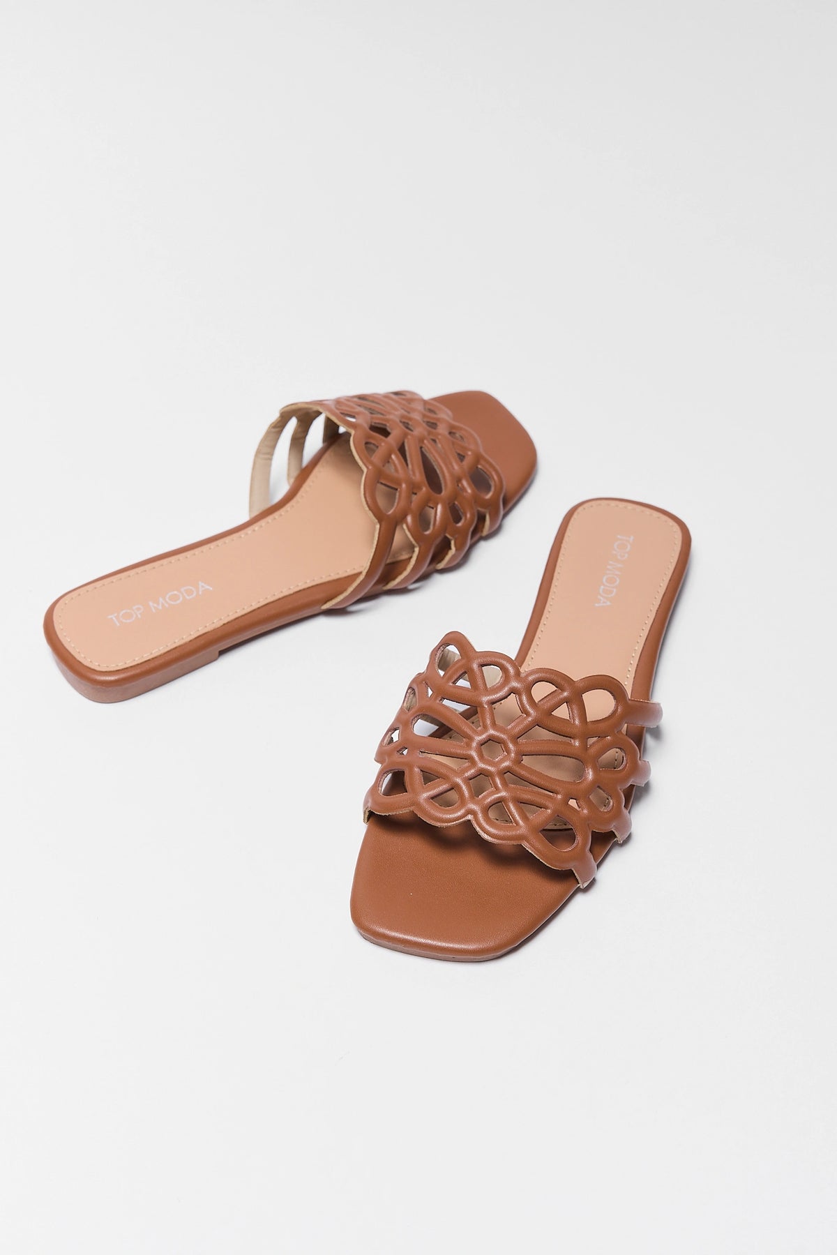 Brown faux-leather cutout floral slide sandals, angled pair view on white background | Avara