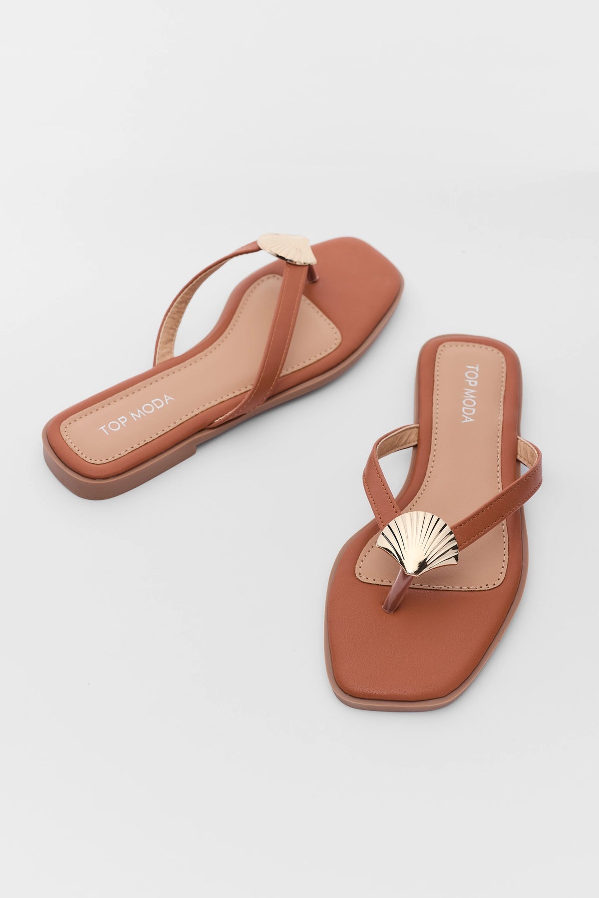 Camel flat sandals with gold shell accent toe strap - Angled Pair View | Avara