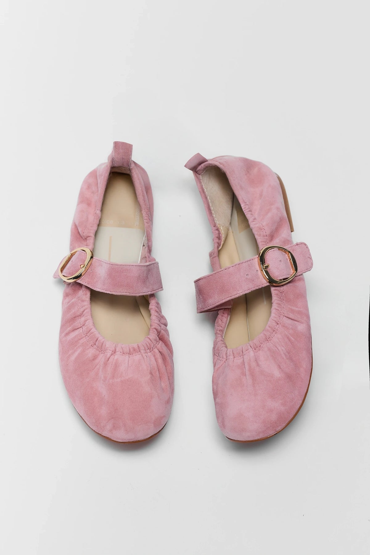 Pair of pink suede ballet flats with gold buckle strap - Top View | Avara