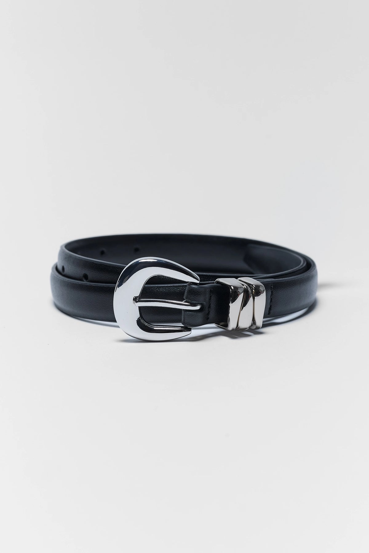 Caroline Black Faux Leather Keeper Belt with silver buckle, coiled flat lay view | Avara