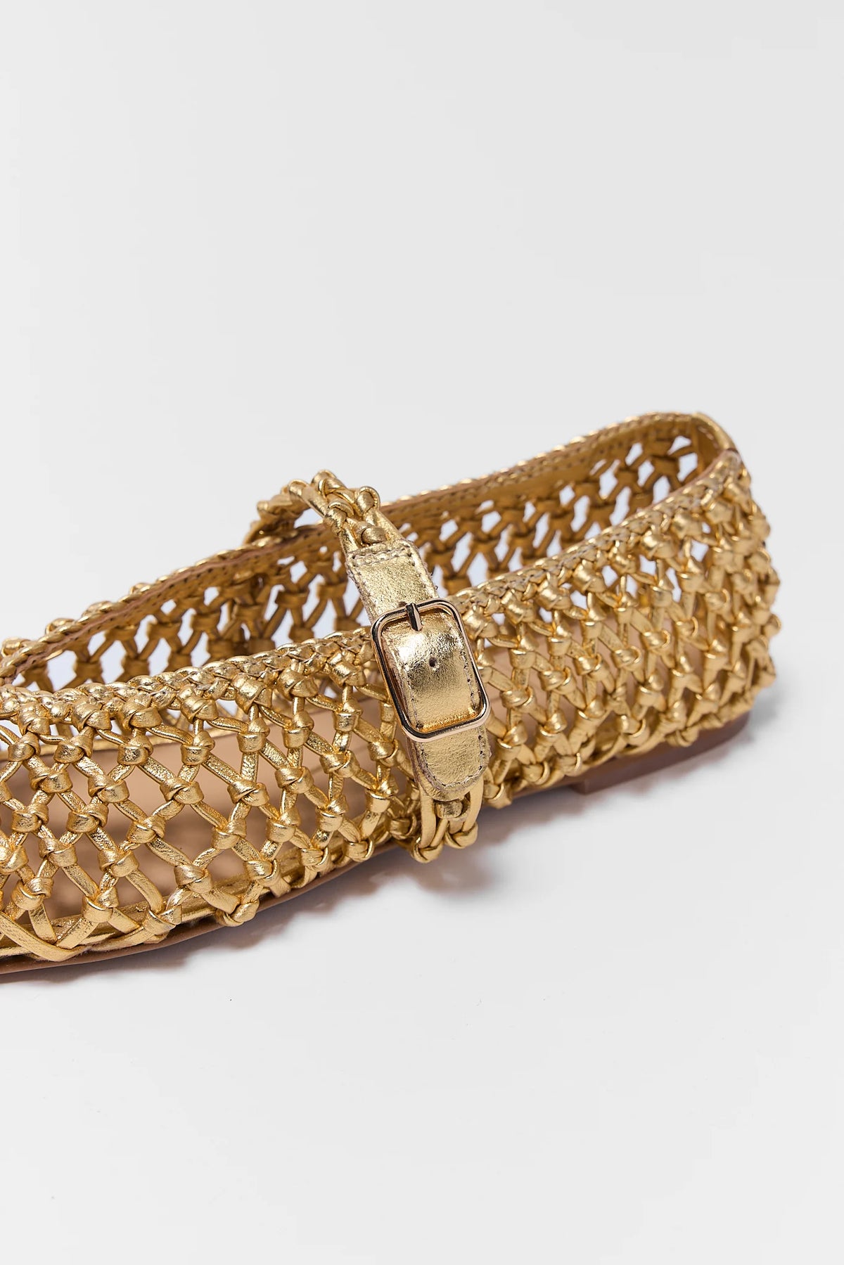 Gold woven leather flat close-up showing adjustable buckle strap detail | Avara