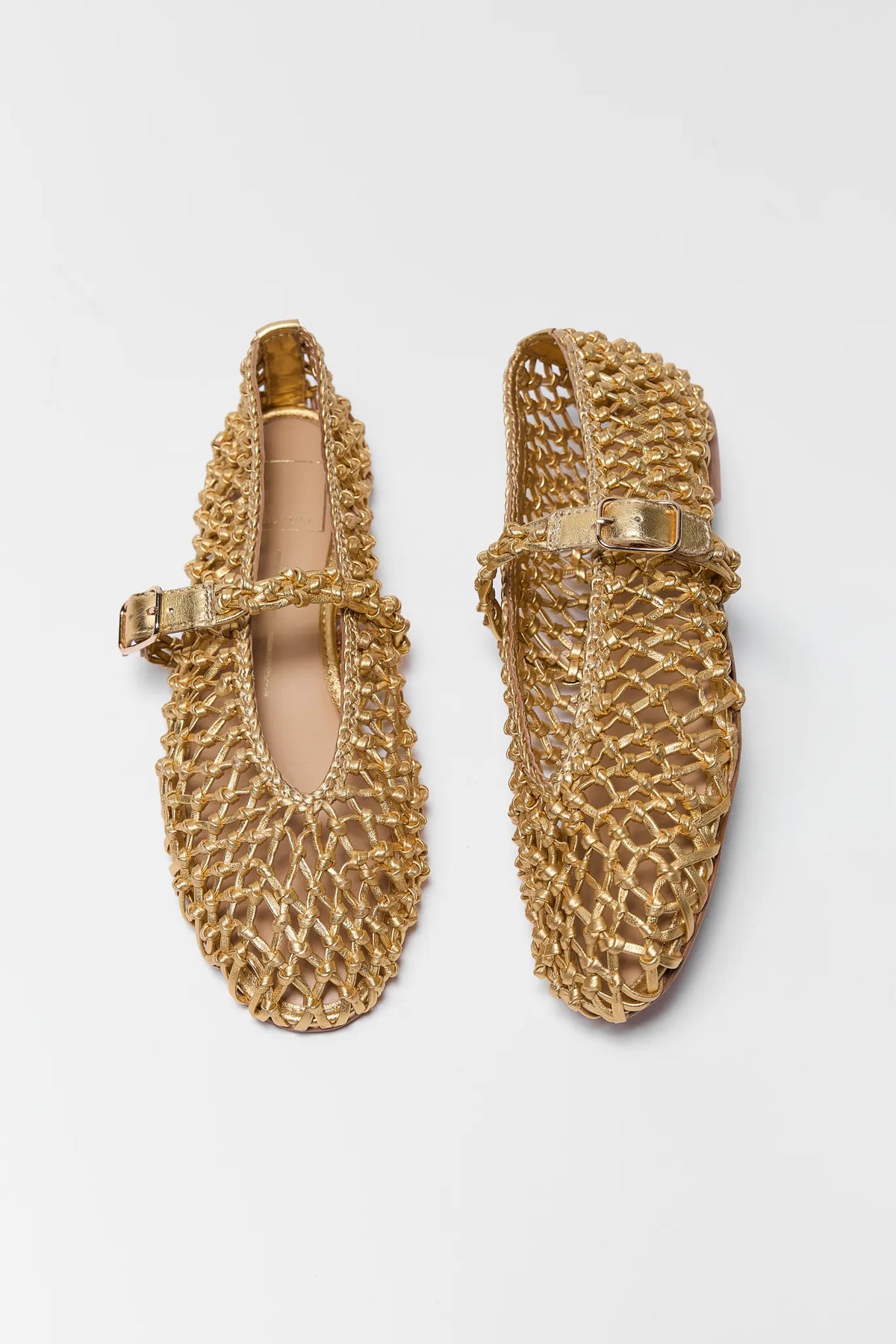 Pair of gold Dolce Vita Clair woven leather flats - Top Down View | Avara