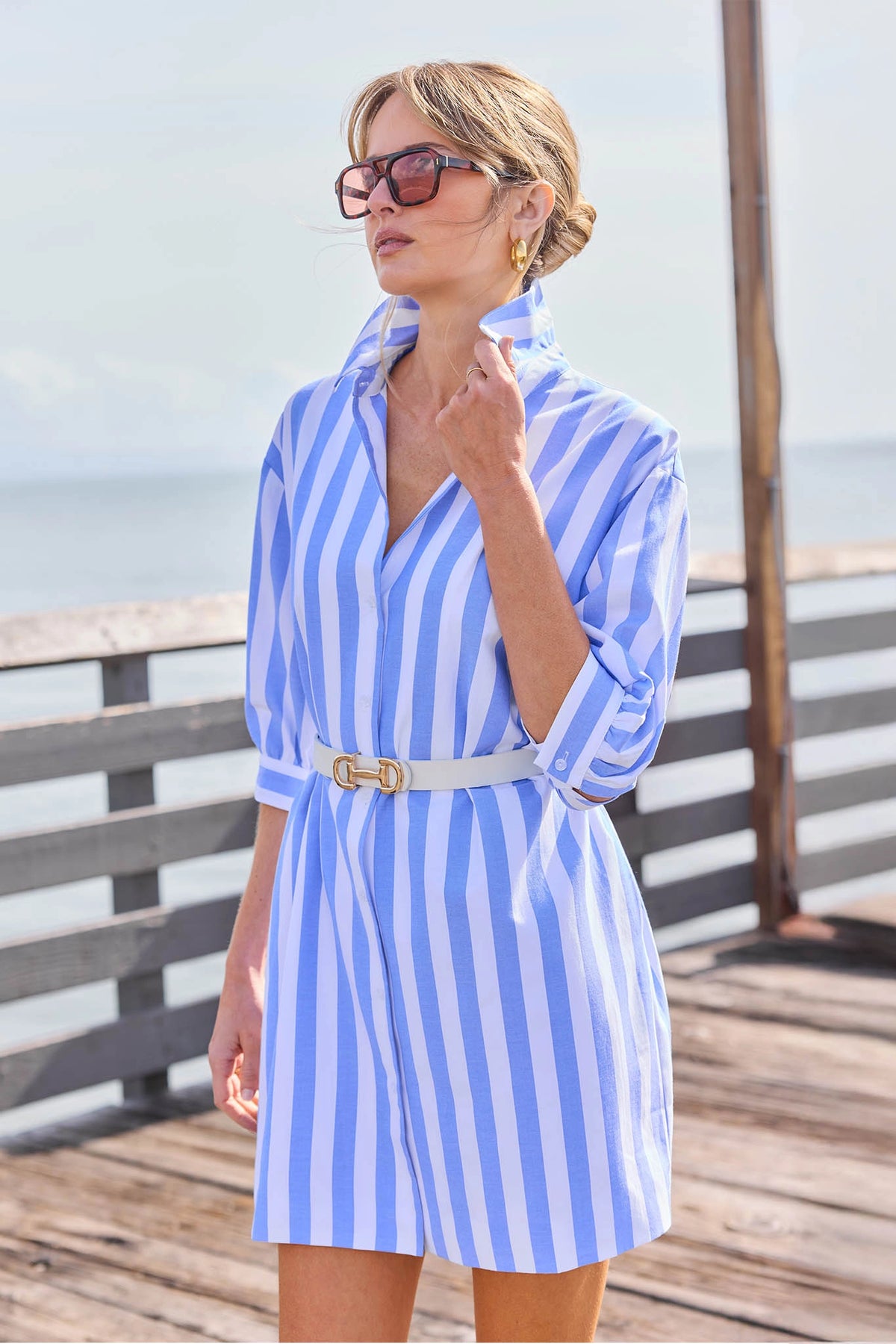 Colby Blue Striped Short Dress styled with white belt on waterfront deck, vacation outfit | Avara