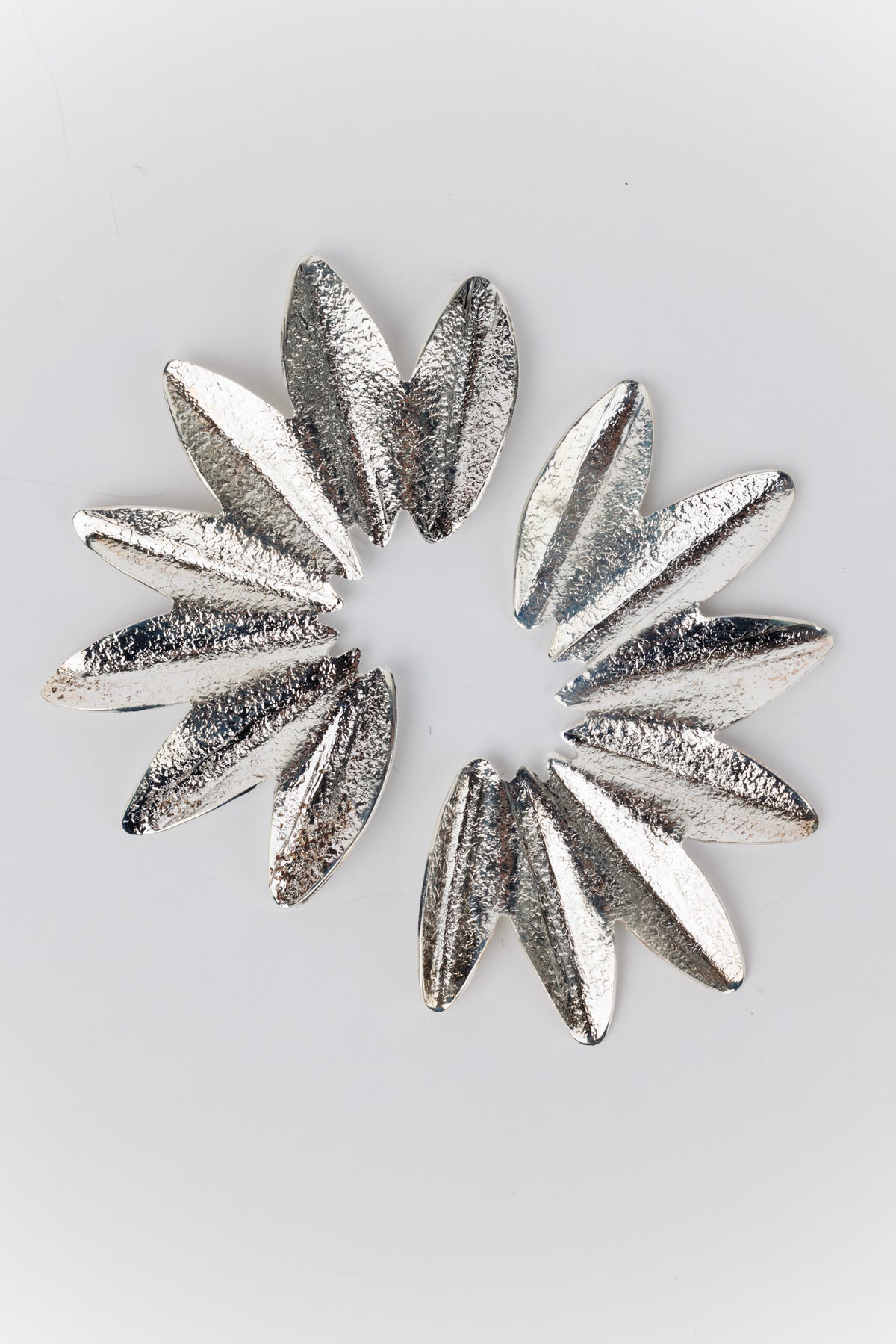 Abientot Silver Earrings: Elongated, reflective metal petals form a hammered texture, creating a stylized flower shape. Lightweight, handmade in Colombia, 2.5 long, lead and nickel-free.