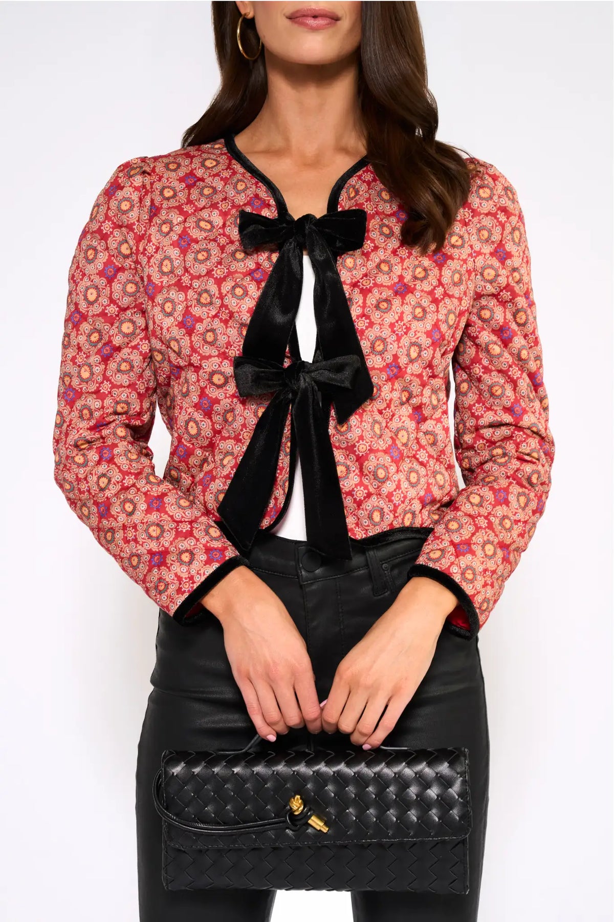 Ember Printed Bow Jacket red quilted medallion print with black velvet bows, close-up front view styled with leather pants and woven clutch | Avara