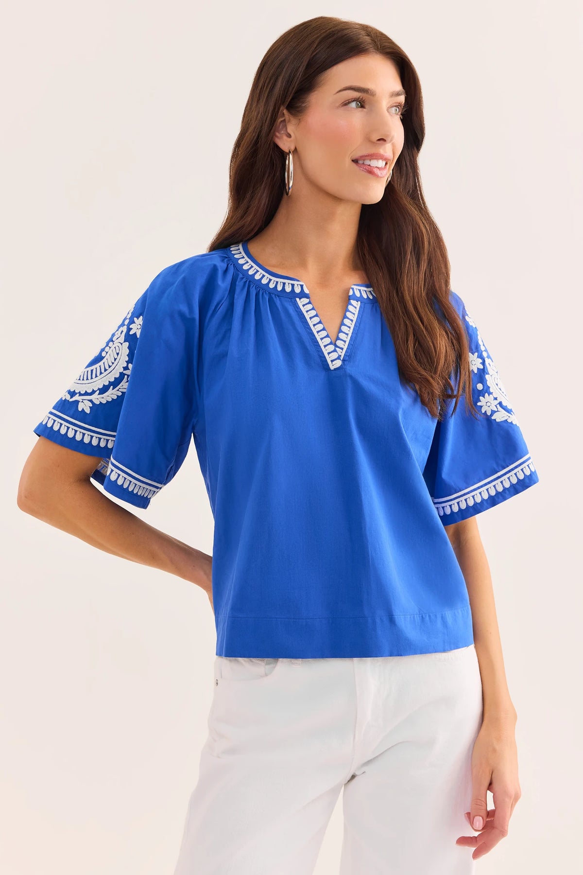 Essie Blue Embroidered Top - Royal Blue with White Floral Sleeve Embroidery, Side Angle On Model | Avara
