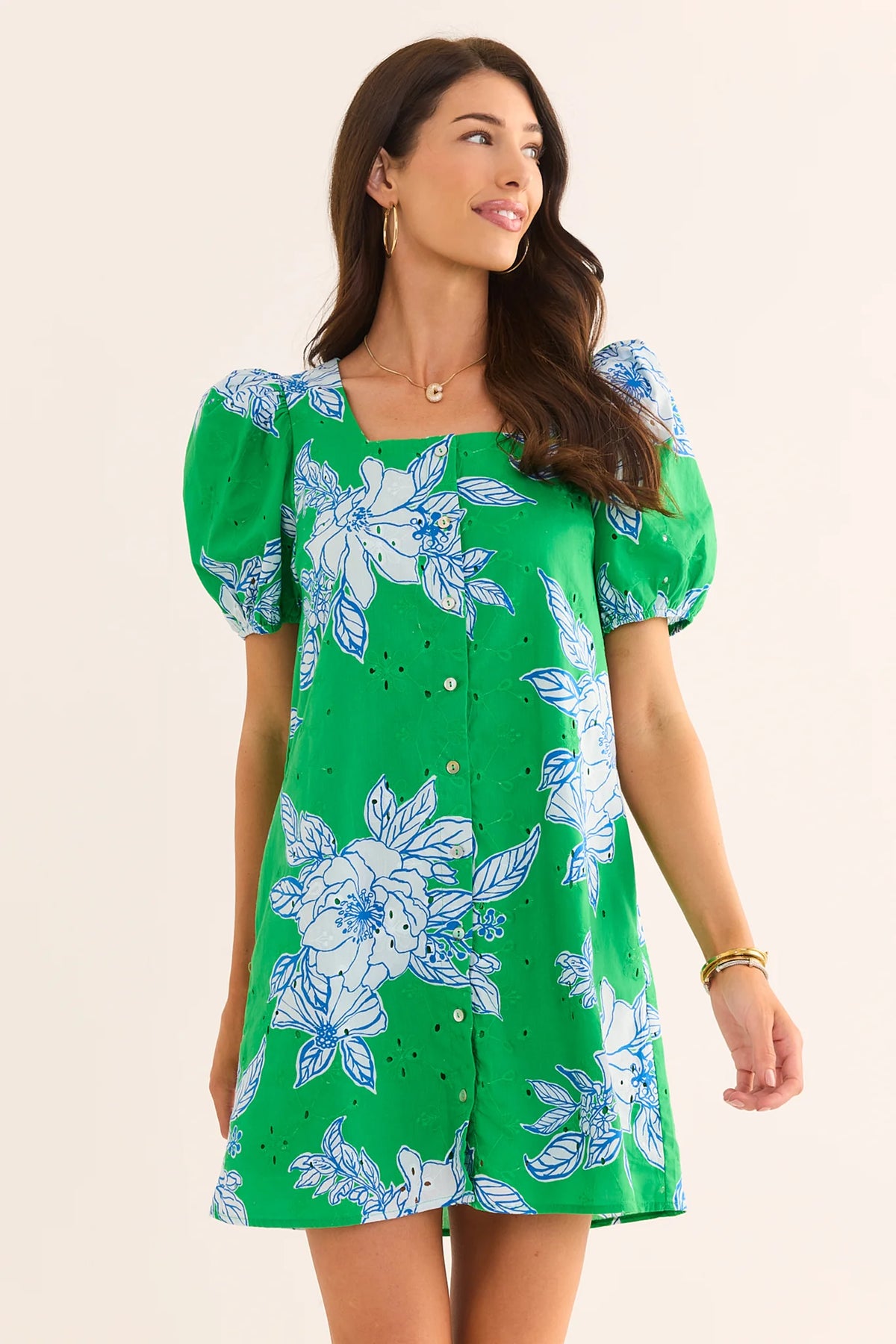 Woman wearing green eyelet floral short dress with puff sleeves, square neckline, front view on model | Avara