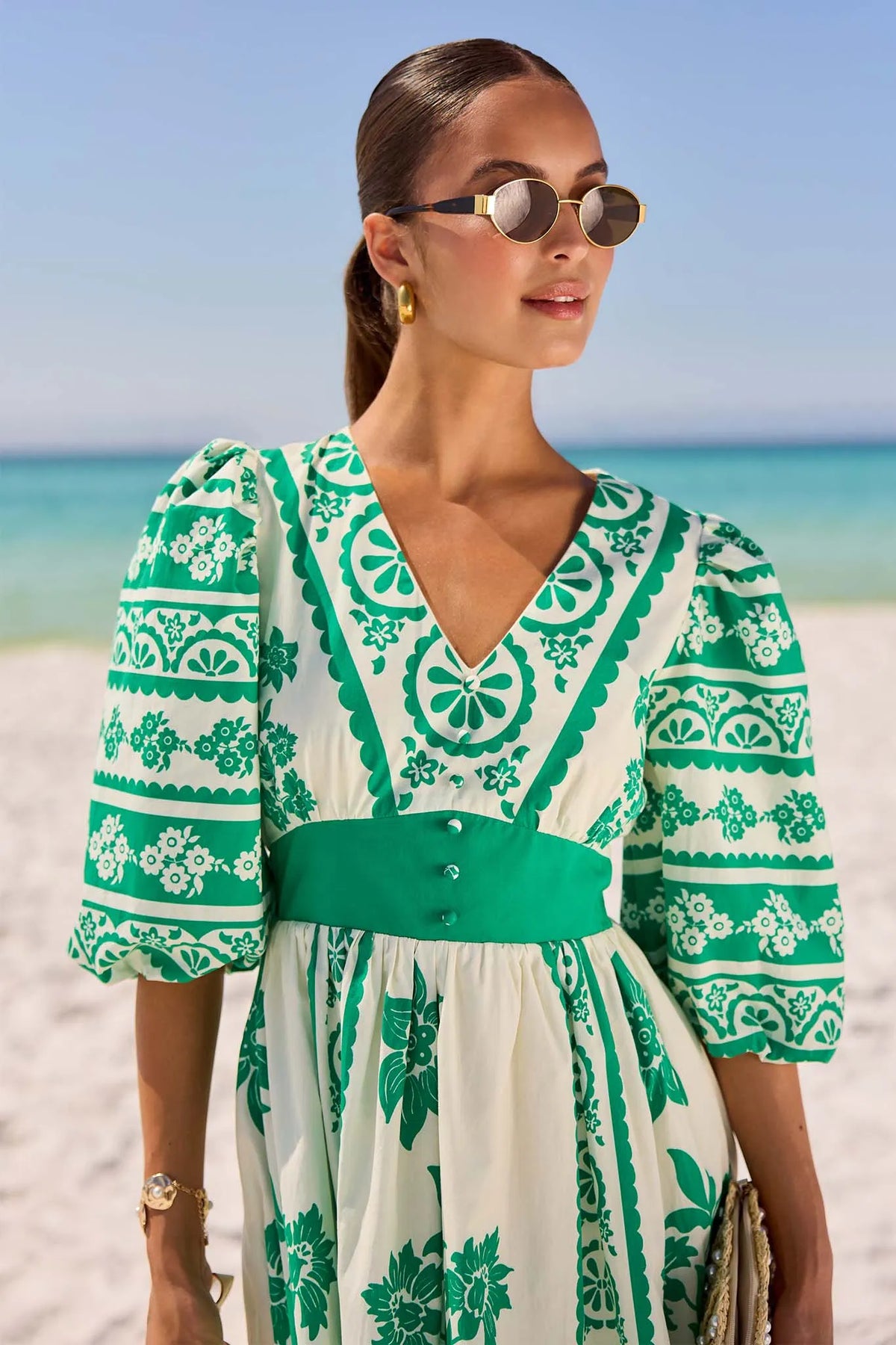 Hadley Green Printed Midi Dress - Close-Up V-Neckline & Puff Sleeve Detail, Beach Setting | Avara