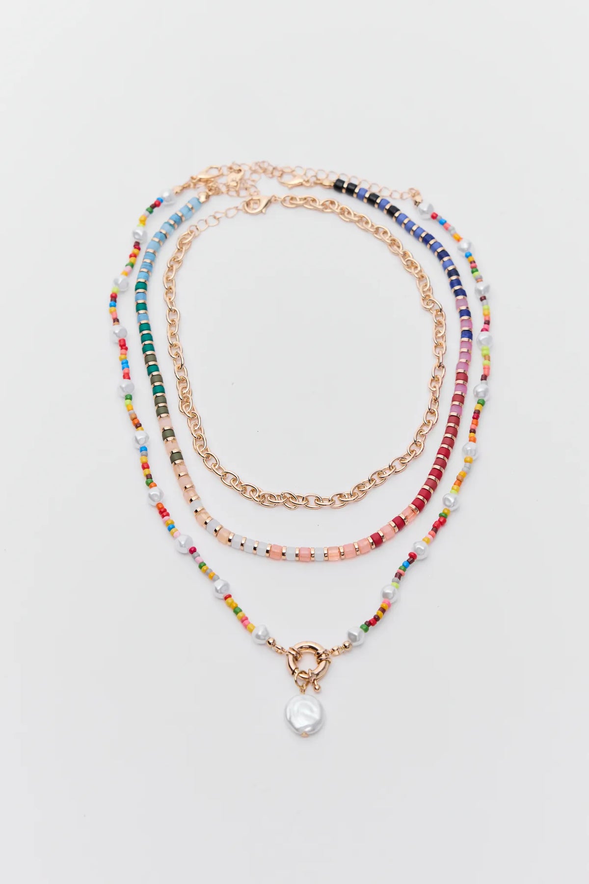 Set of multicolored beaded necklaces on a light gray background
