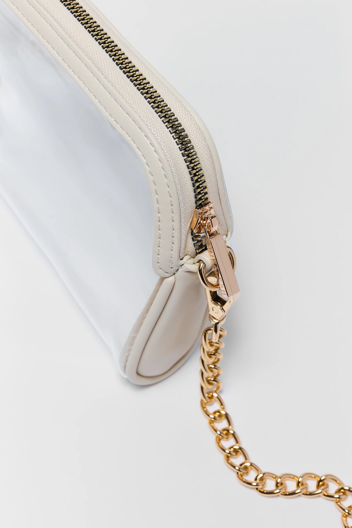 Ivory Trim Clear Crossbody Bag close up of gold zipper and chain hardware detail | Avara