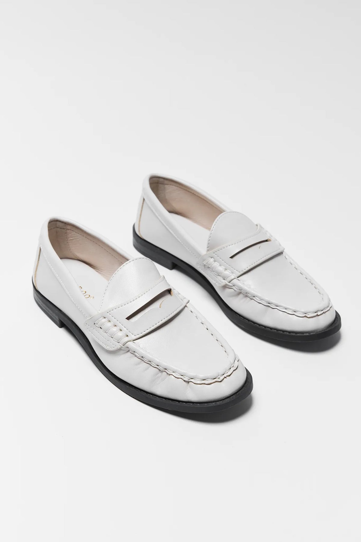 Pair of Jacklyn Cream Faux Leather Loafers - Angled Three-Quarter View | Avara