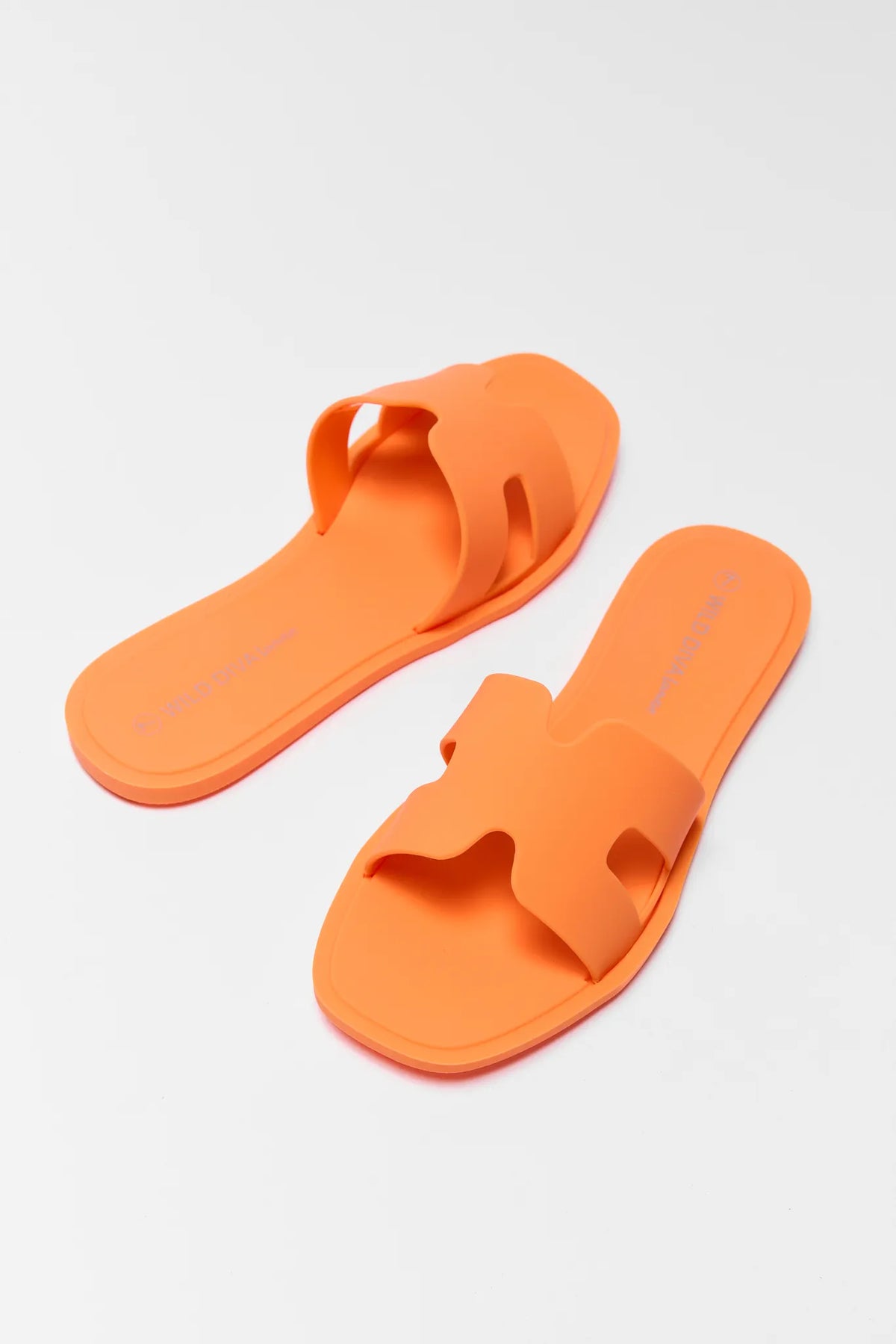 Orange jelly sandals pair with H-strap cutout detail, angled view | Avara