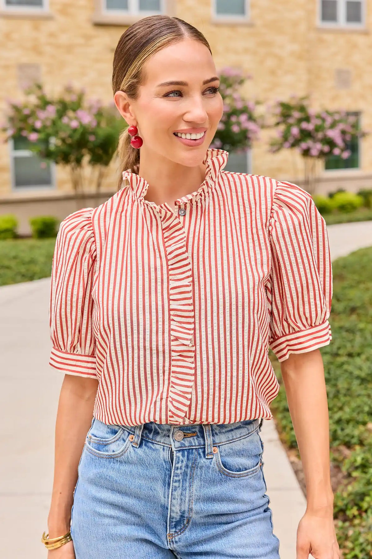 Jules Red Stripe Ruffle Trim Top with puff sleeves, styled with light wash jeans outdoors - Lifestyle Look | Avara