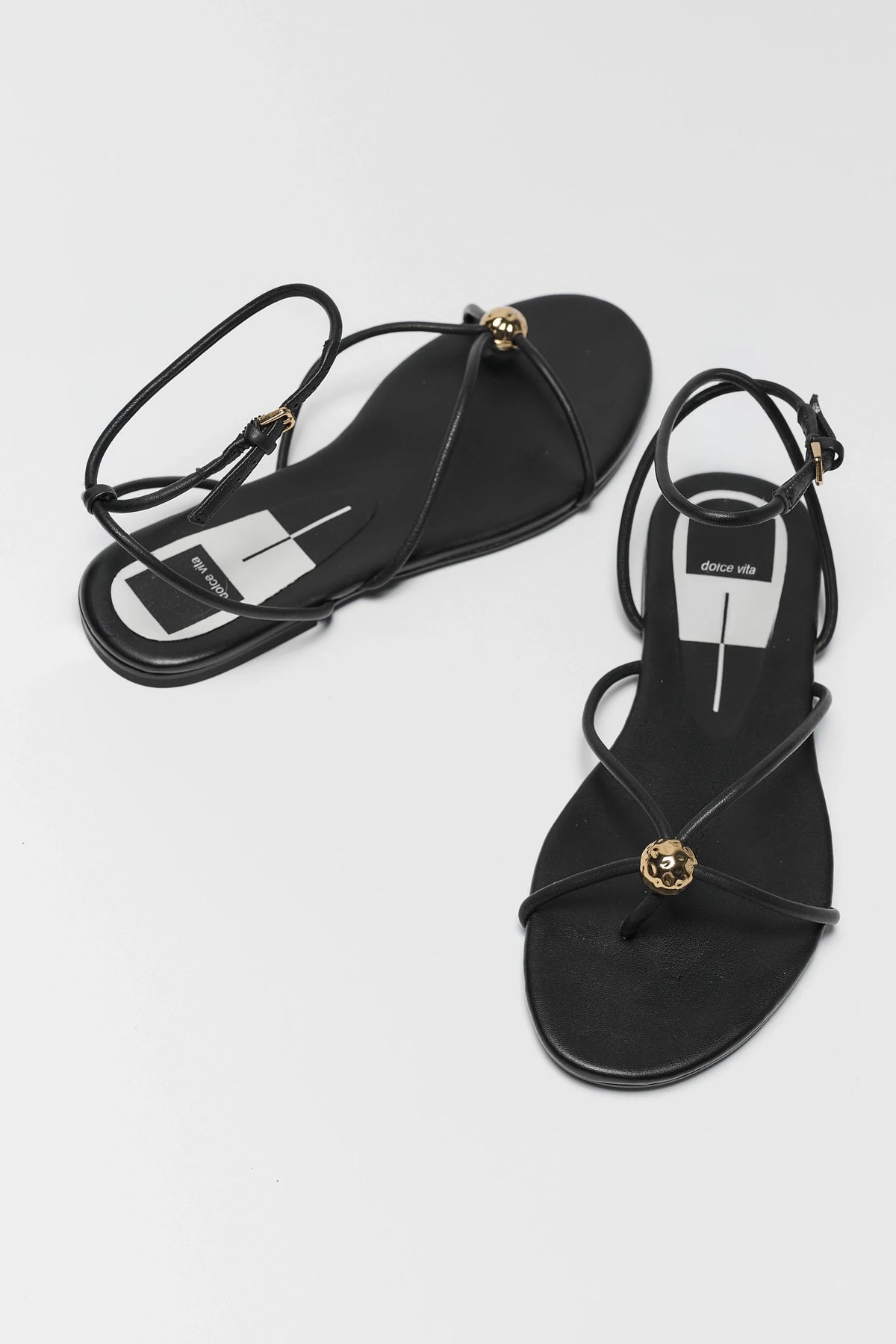 Black leather Kenley sandals by Dolce Vita with gold ball detail - Top Overhead View | Avara