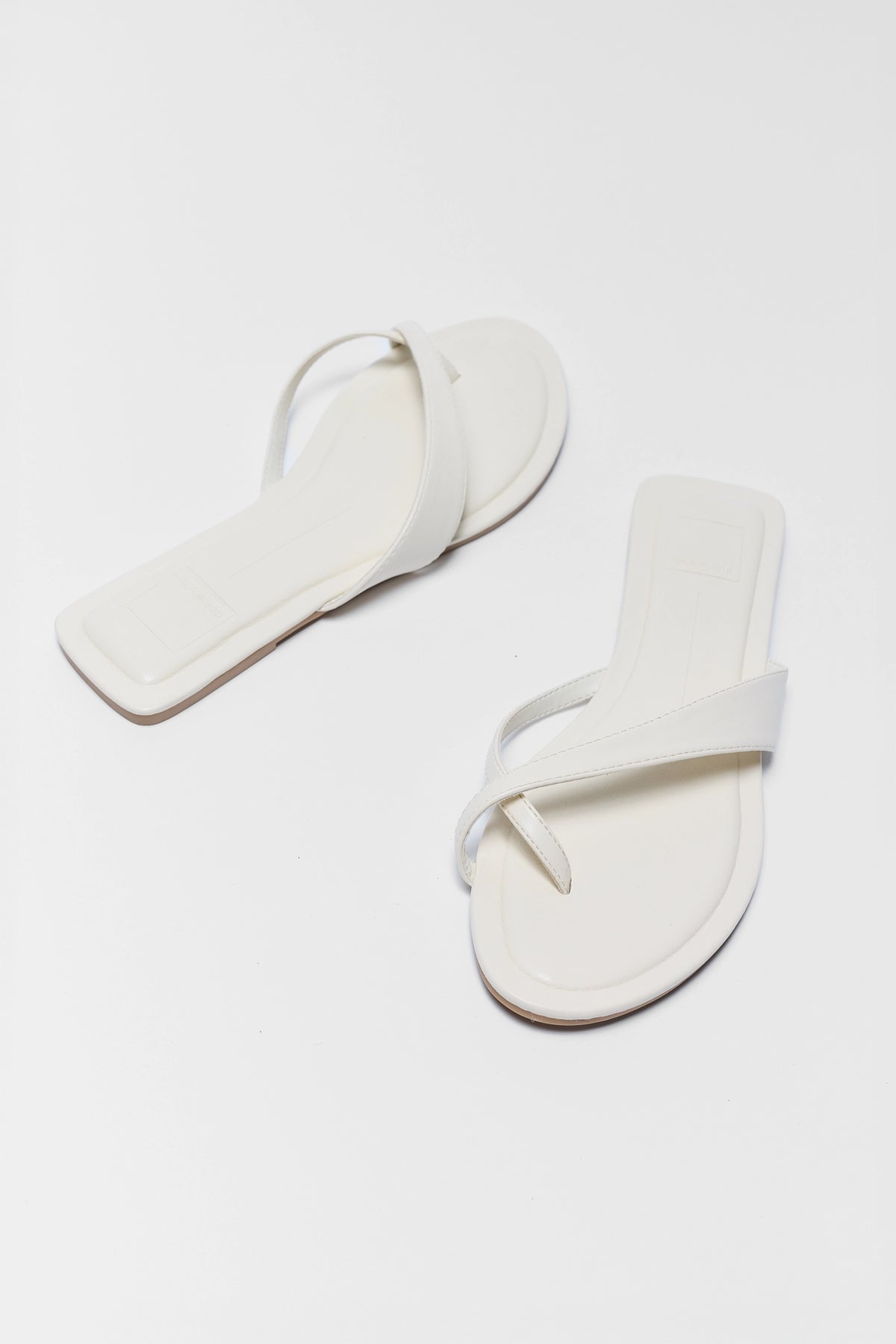 Pair of white crossover sandals angled side view - Dolce Vita Lenex | Avara