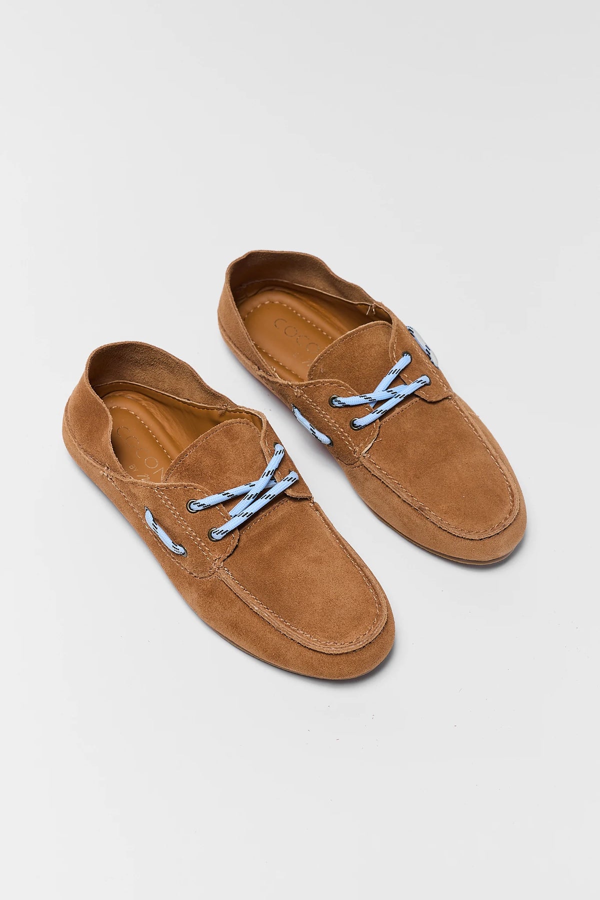 Women's light brown suede boat shoes with blue laces, tan insole - Flat Lay | Avara