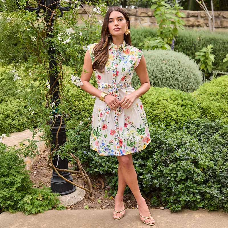 Woman in a floral dress standing in a garden