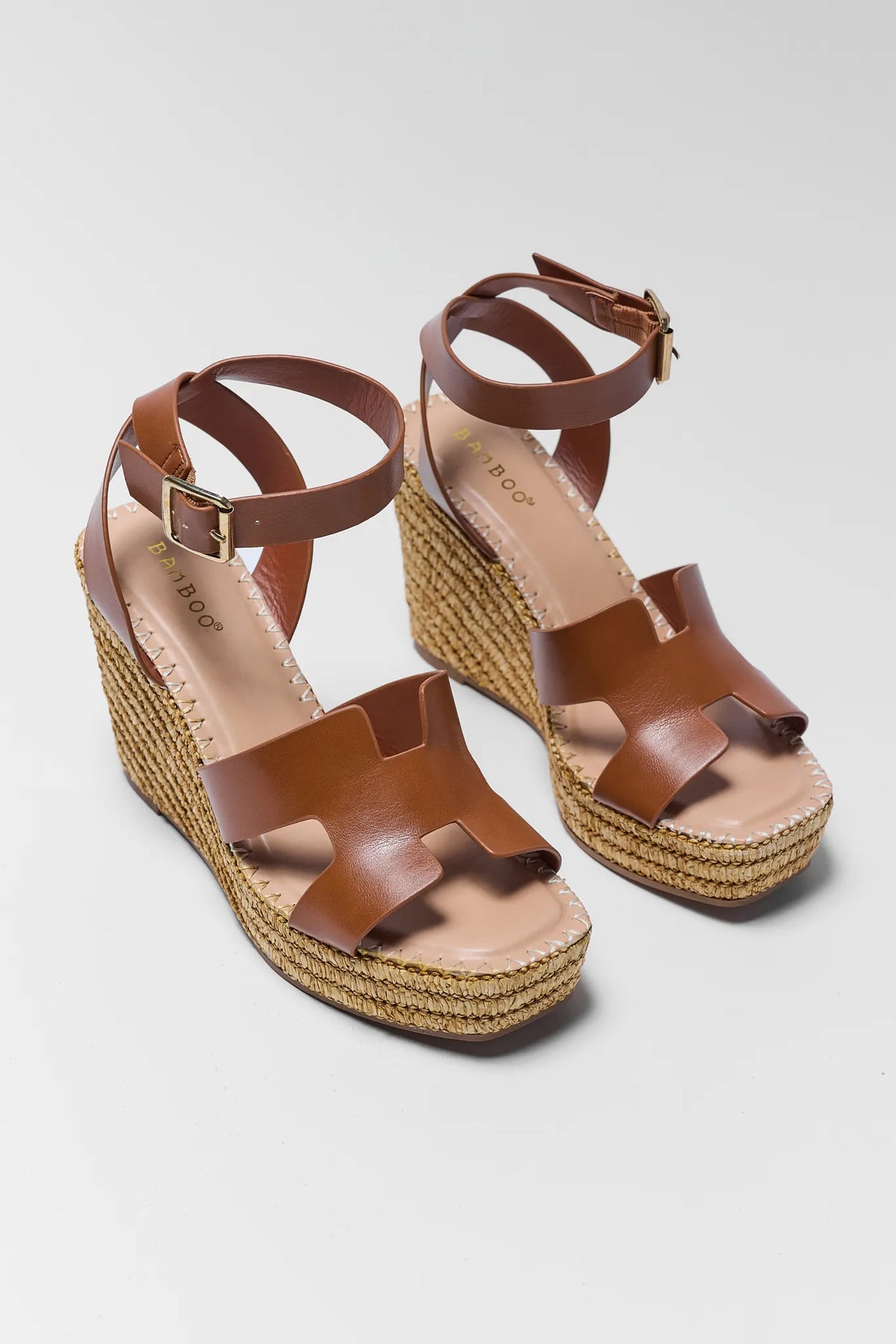 Chestnut brown wedge sandals with woven raffia espadrille sole and ankle strap - Front Angle Pair | Avara