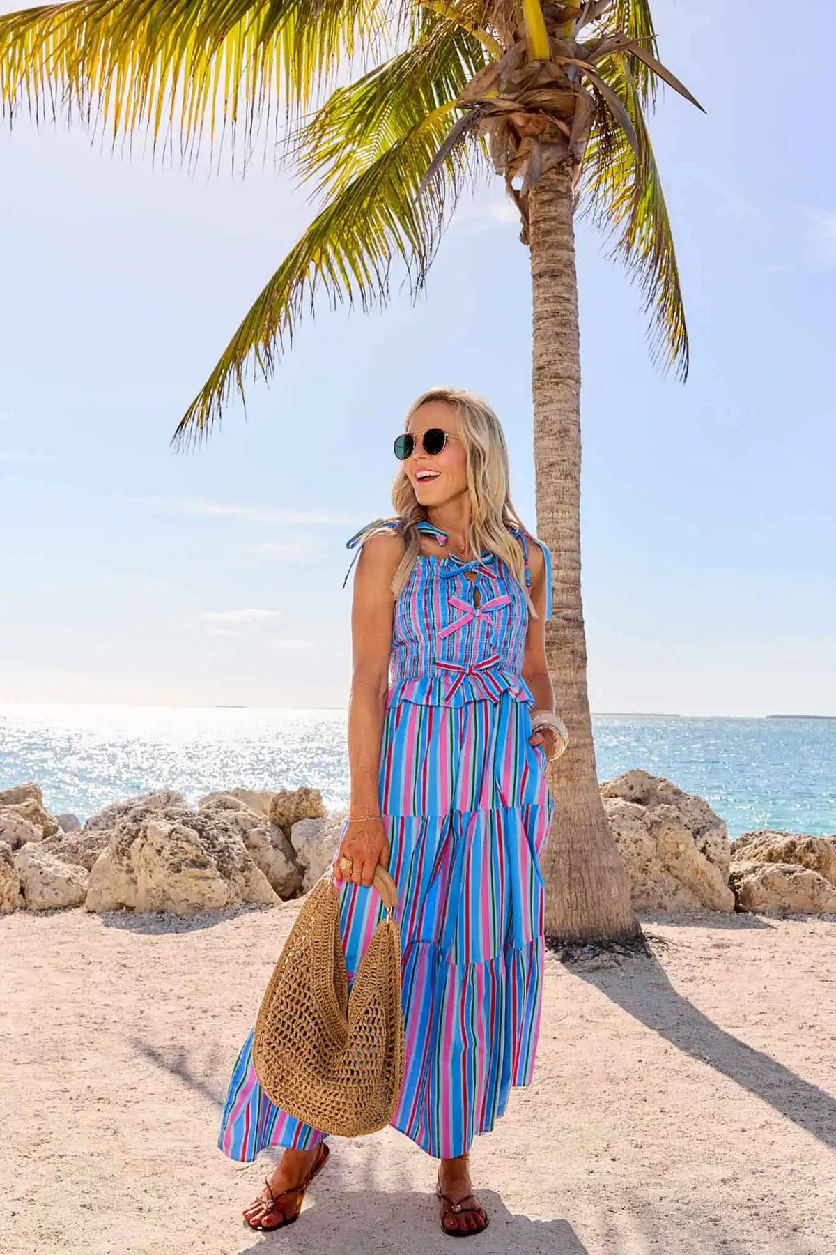 Margot Blue Striped Maxi Dress styled at beach with palm tree - Resort Wear Lifestyle Look | Avara