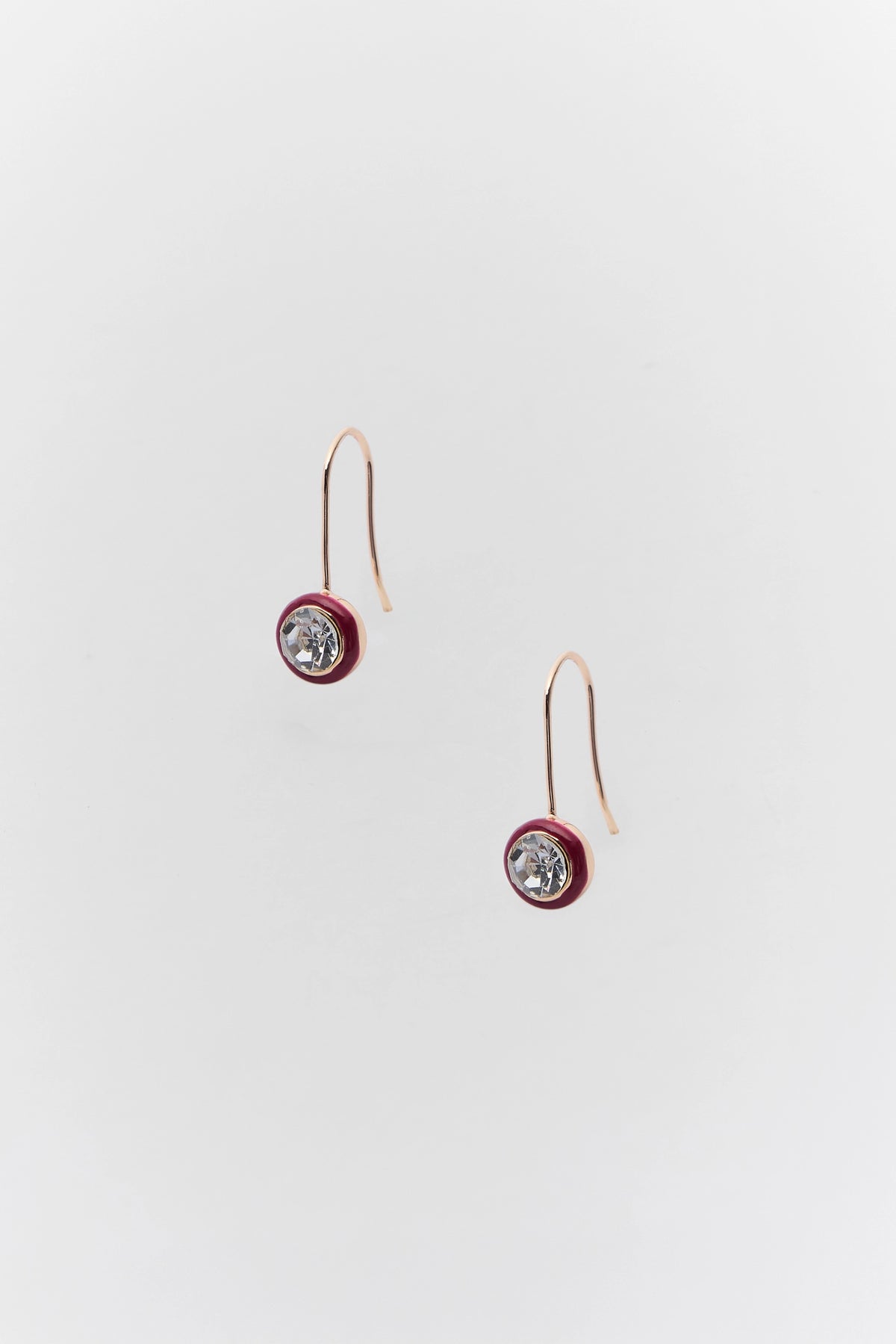Maroon round rhinestone drop earrings with gold-tone hooks - flat lay view | Avara