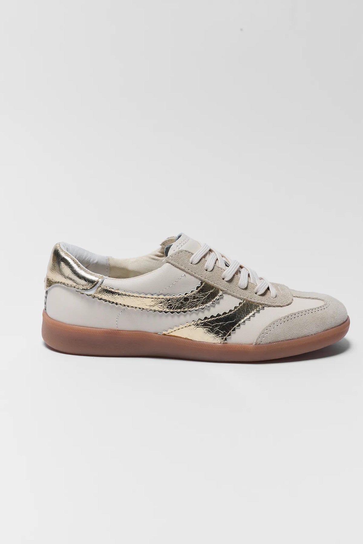 Dolce Vita Merit Gold Sneaker - Side Profile, Cream Leather with Gold Metallic Stripe and Gum Sole | Avara