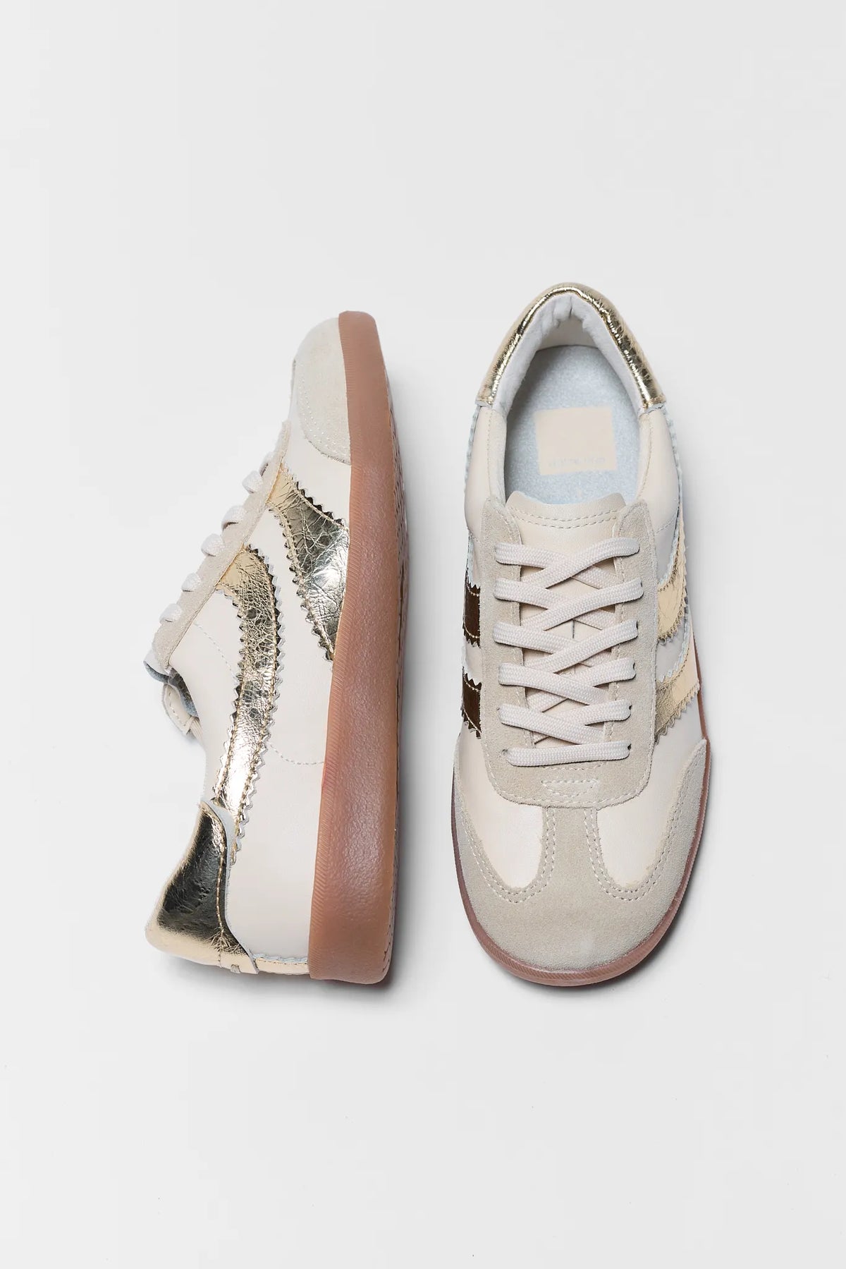 Dolce Vita Merit Gold Sneakers - Top & Side View, Cream Leather with Metallic Gold Accents and Gum Sole | Avara