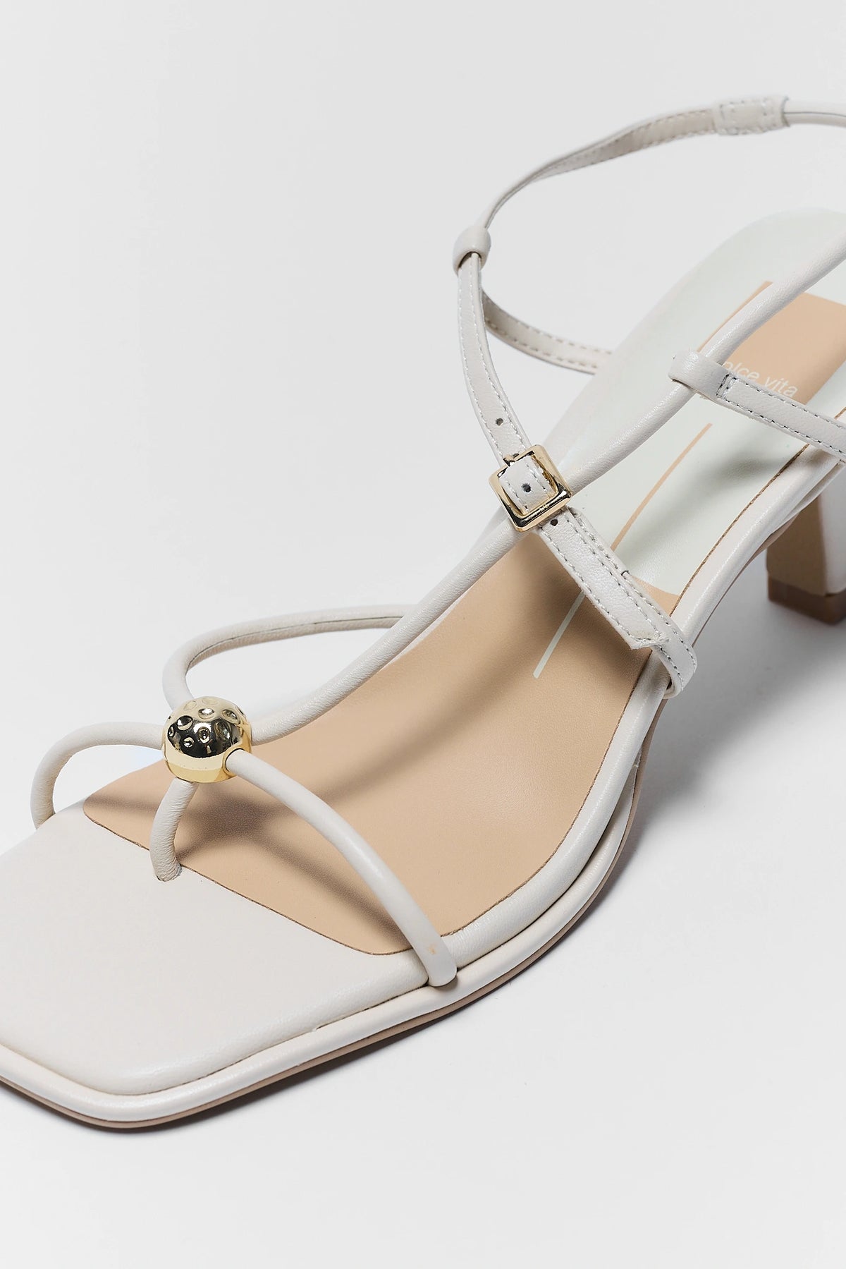 Mylee Cream Strappy Kitten Heels Close-Up Gold Ball Hardware Detail | Avara